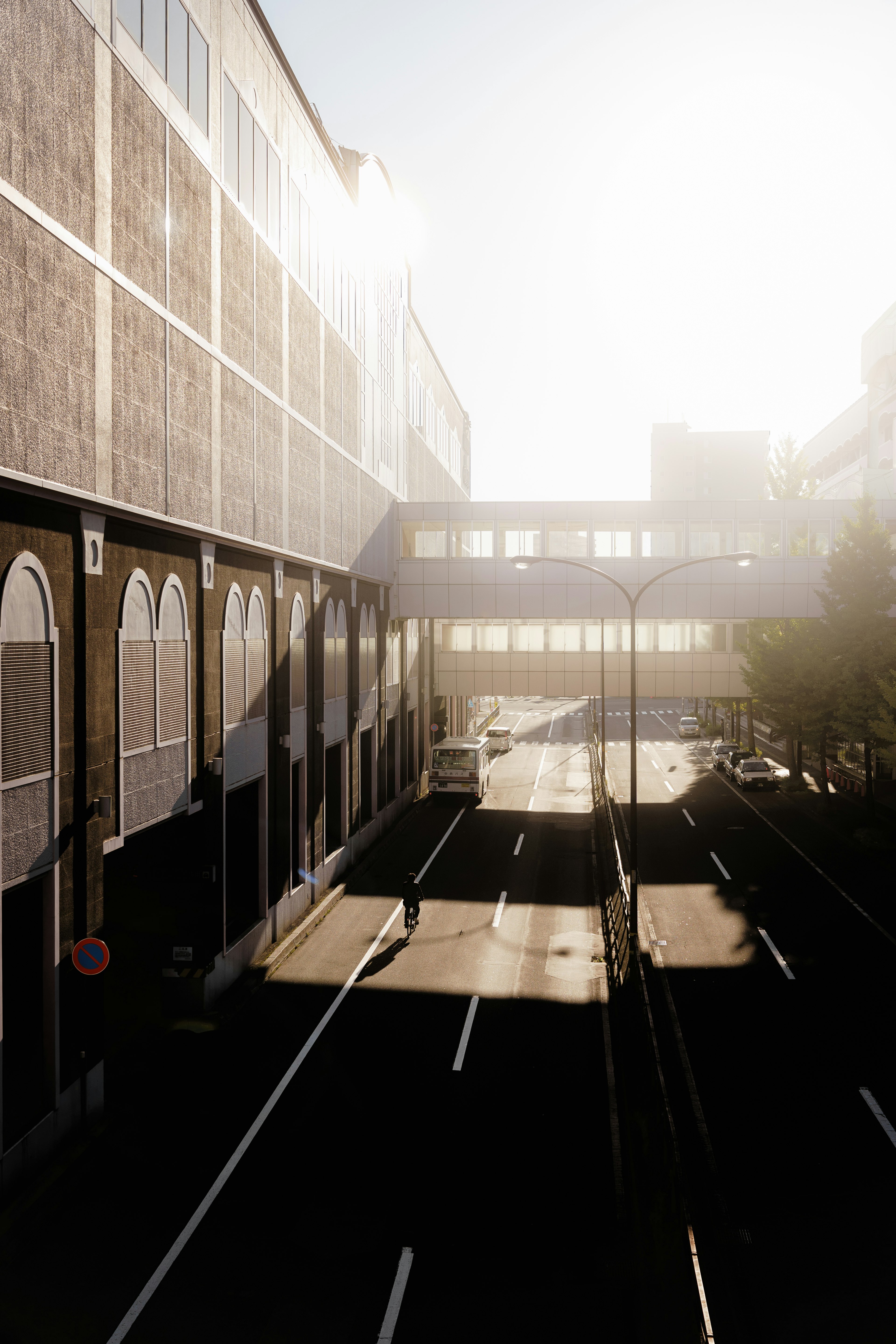 Urban street scene with buildings illuminated by bright sunlight