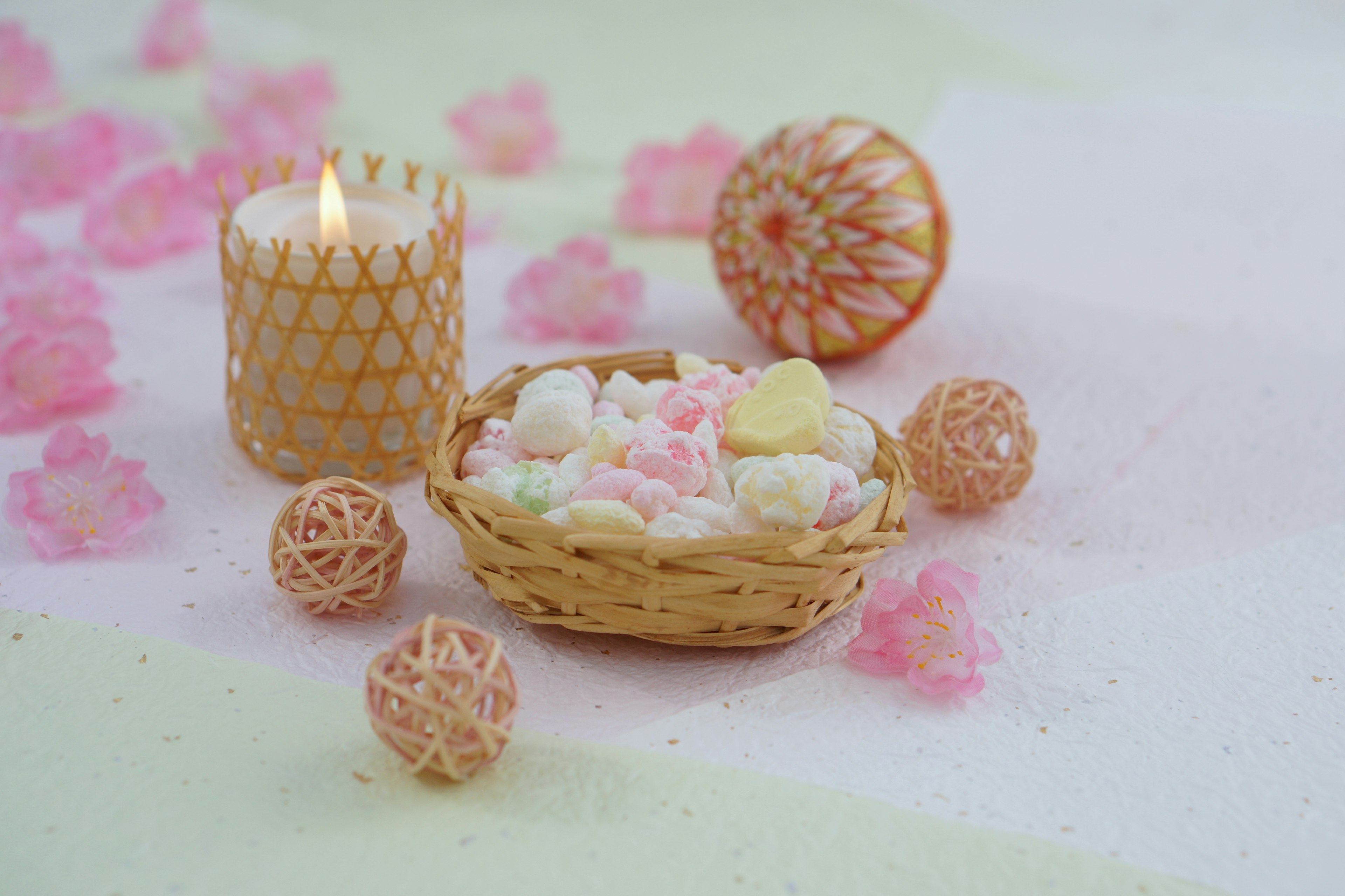 Dulces coloridos en una pequeña canasta con una vela decorativa y adornos