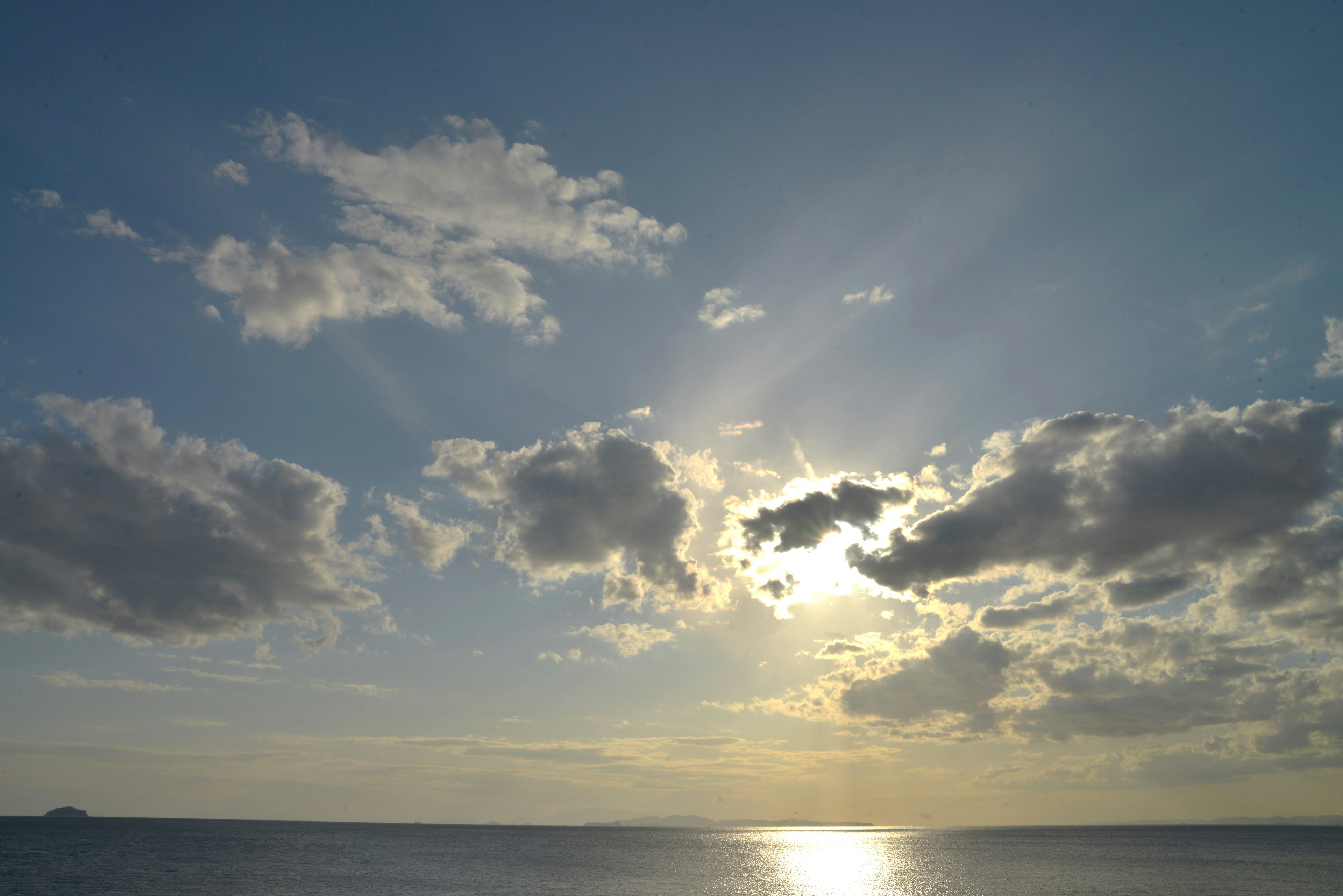 Blue sky with clouds and shining sunlight