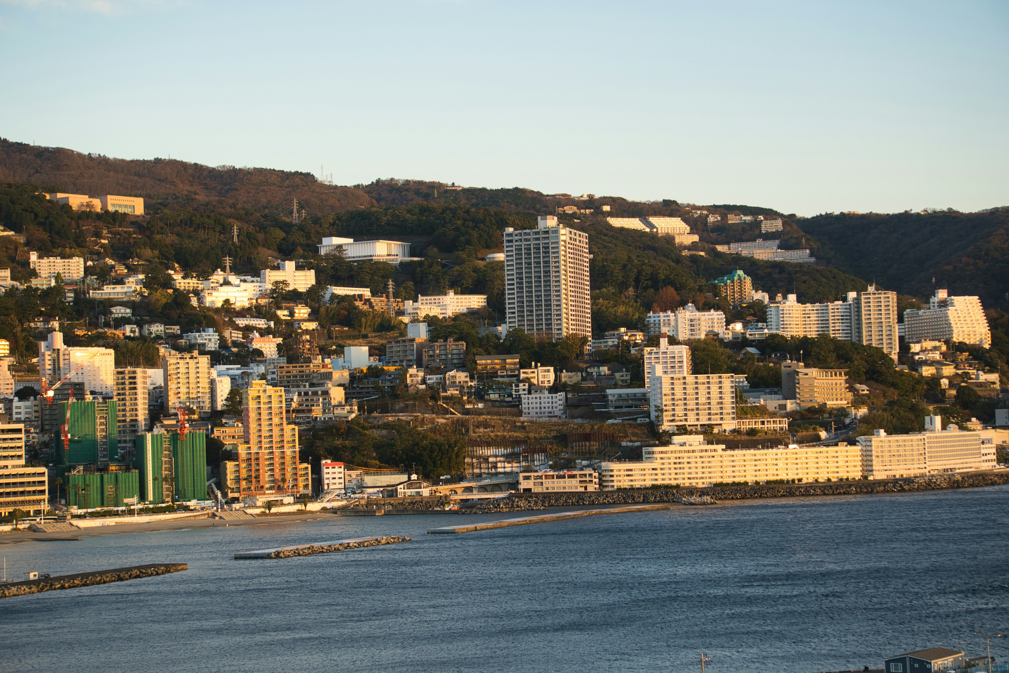 Coastal cityscape with high-rise buildings and residential areas overlooking the sea