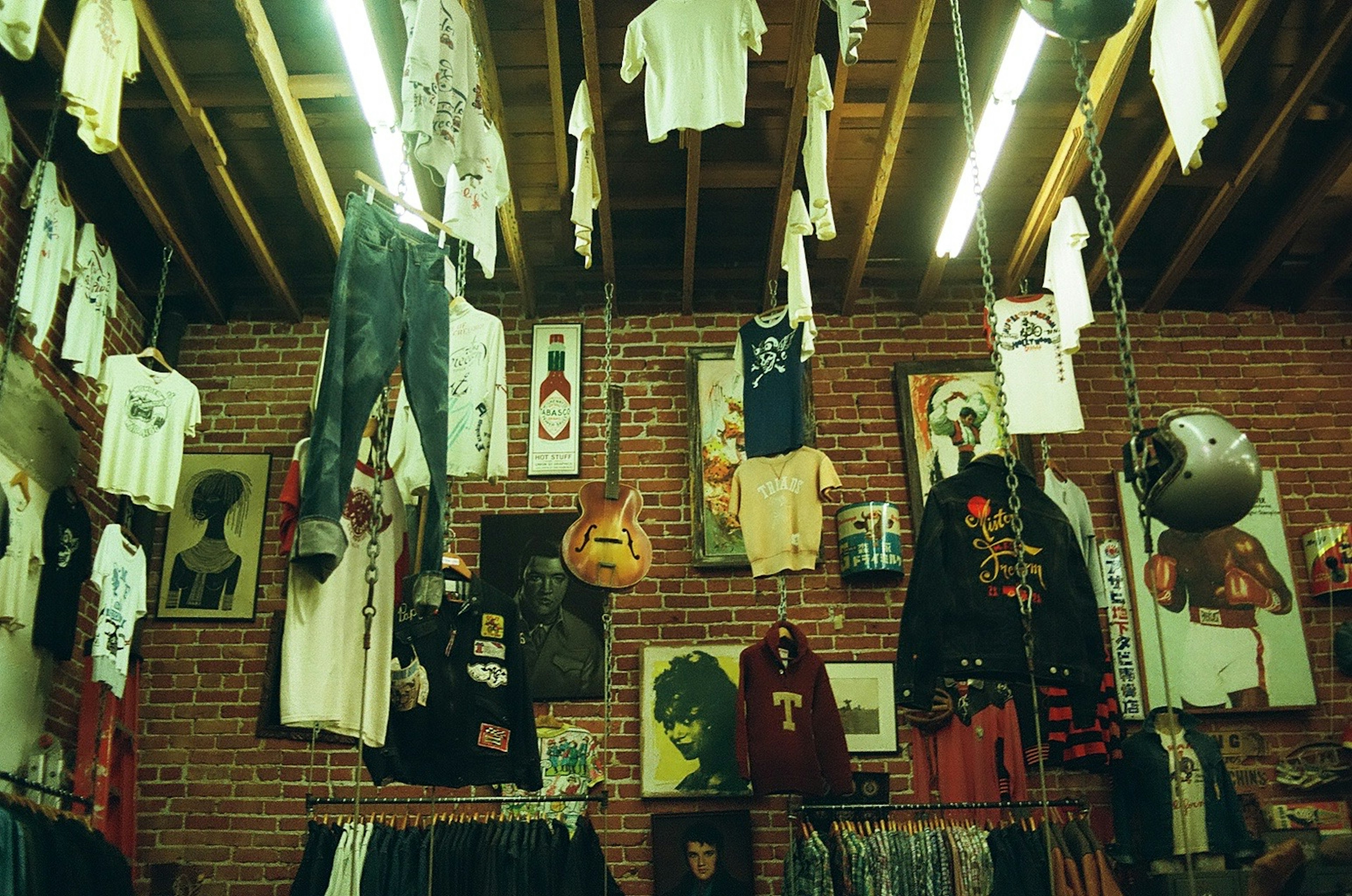 Interior of a clothing store with casual wear hanging and art pieces