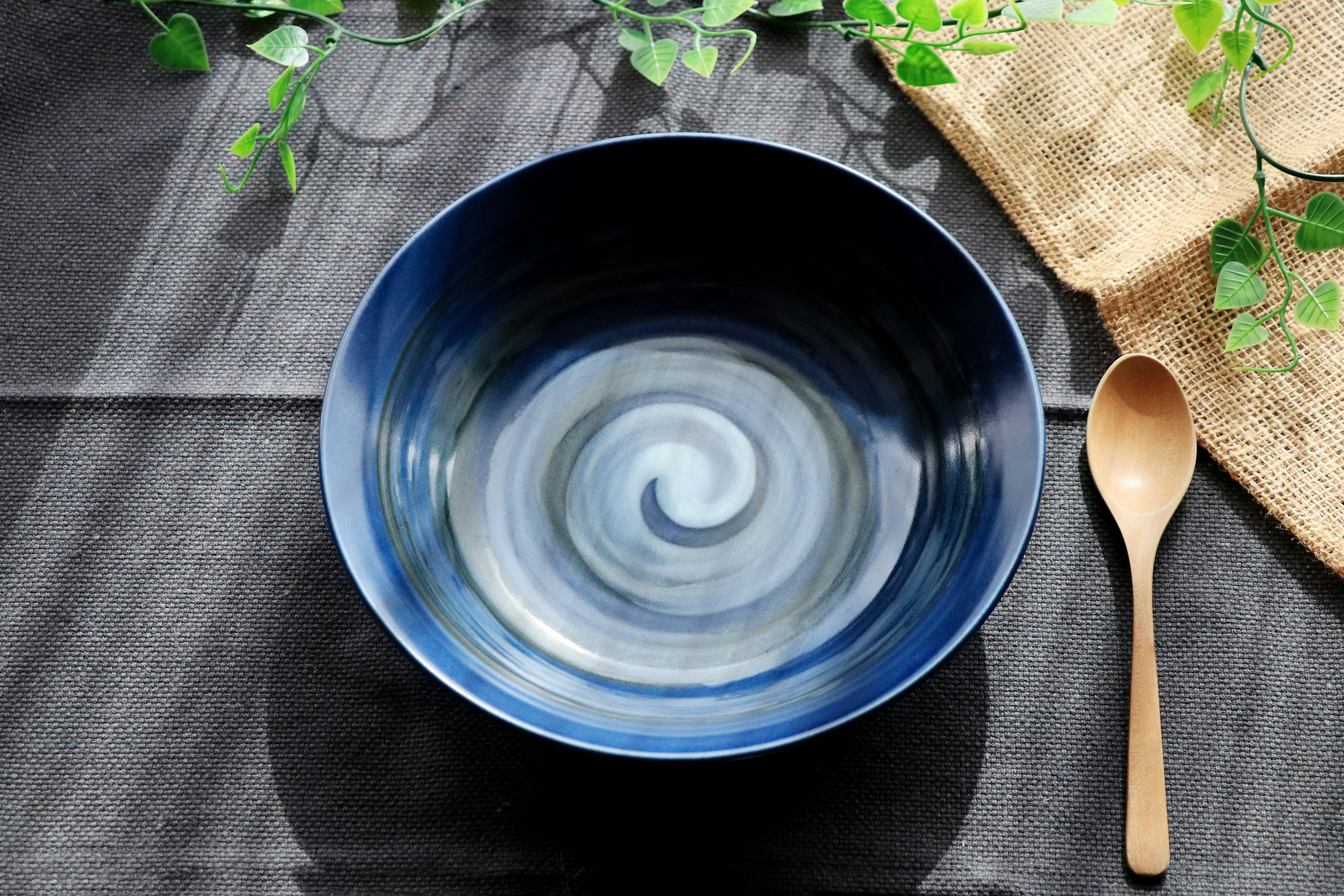 Blue swirl patterned bowl with a wooden spoon