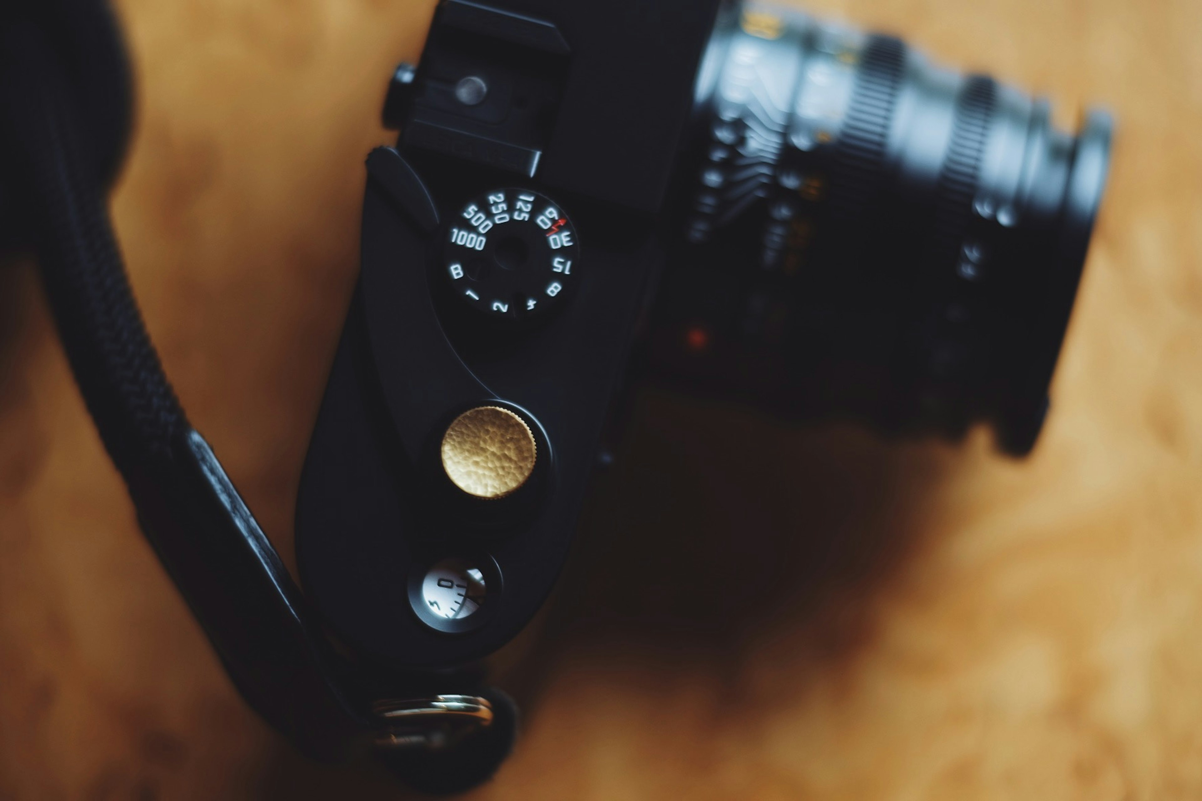 Close-up of a camera top view black body visible lens and dial