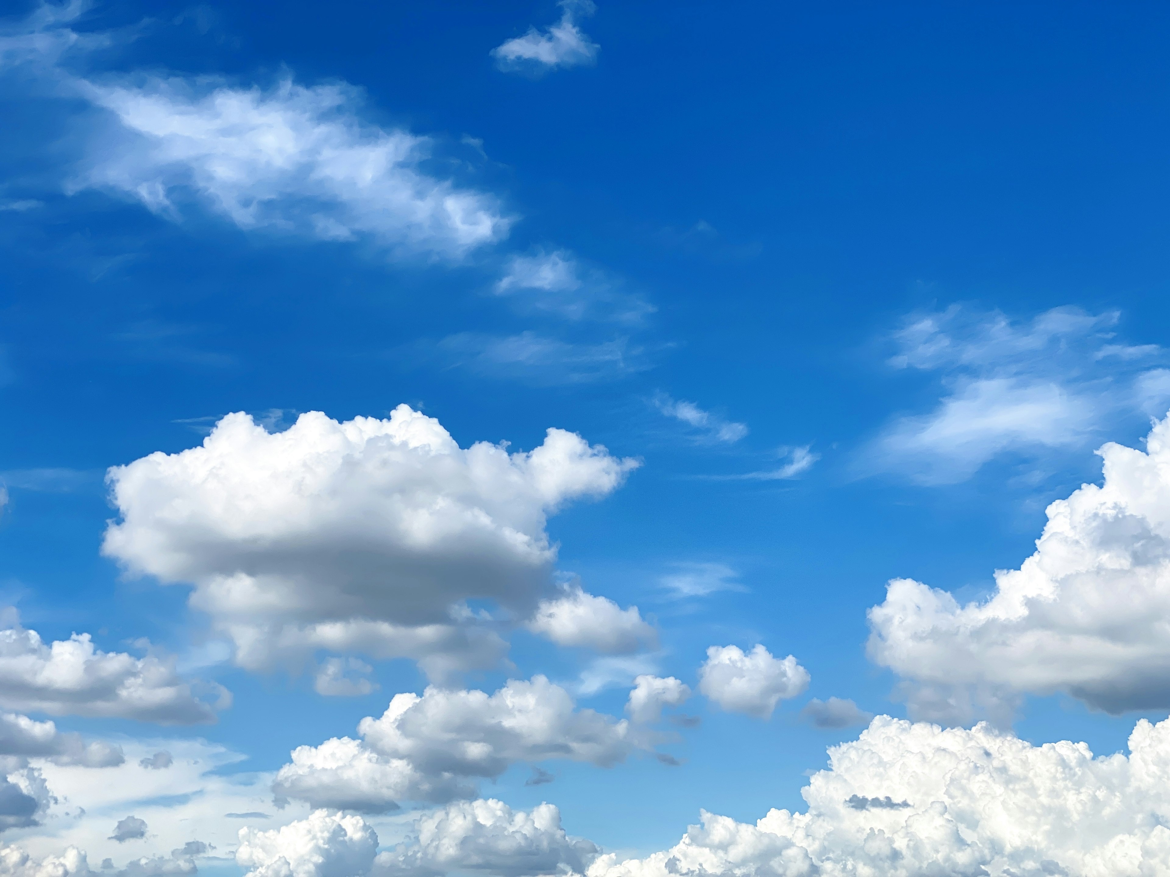 Landschaft mit weißen Wolken, die in einem blauen Himmel schweben