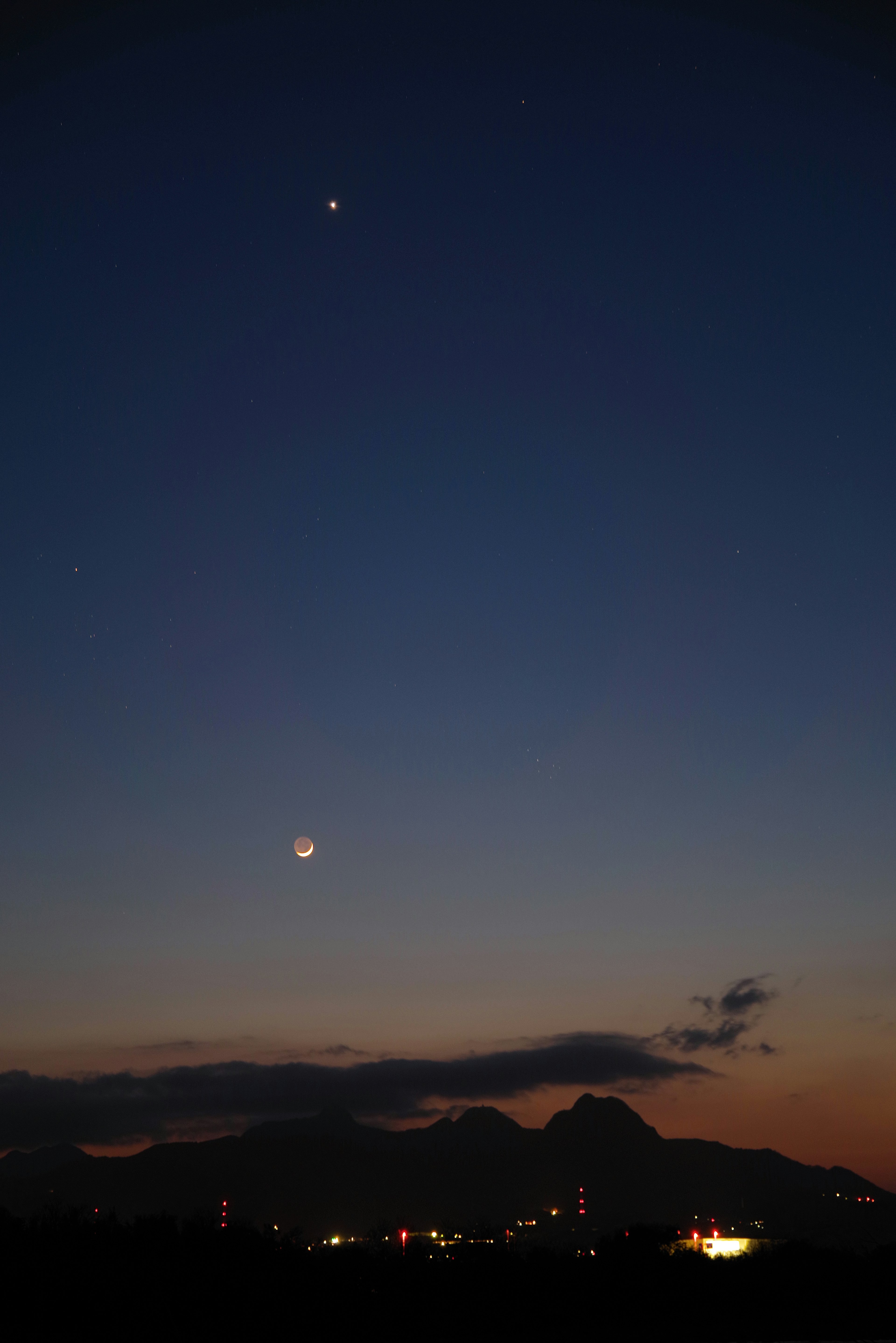 Beautiful contrast of mountains and starry sky at dusk