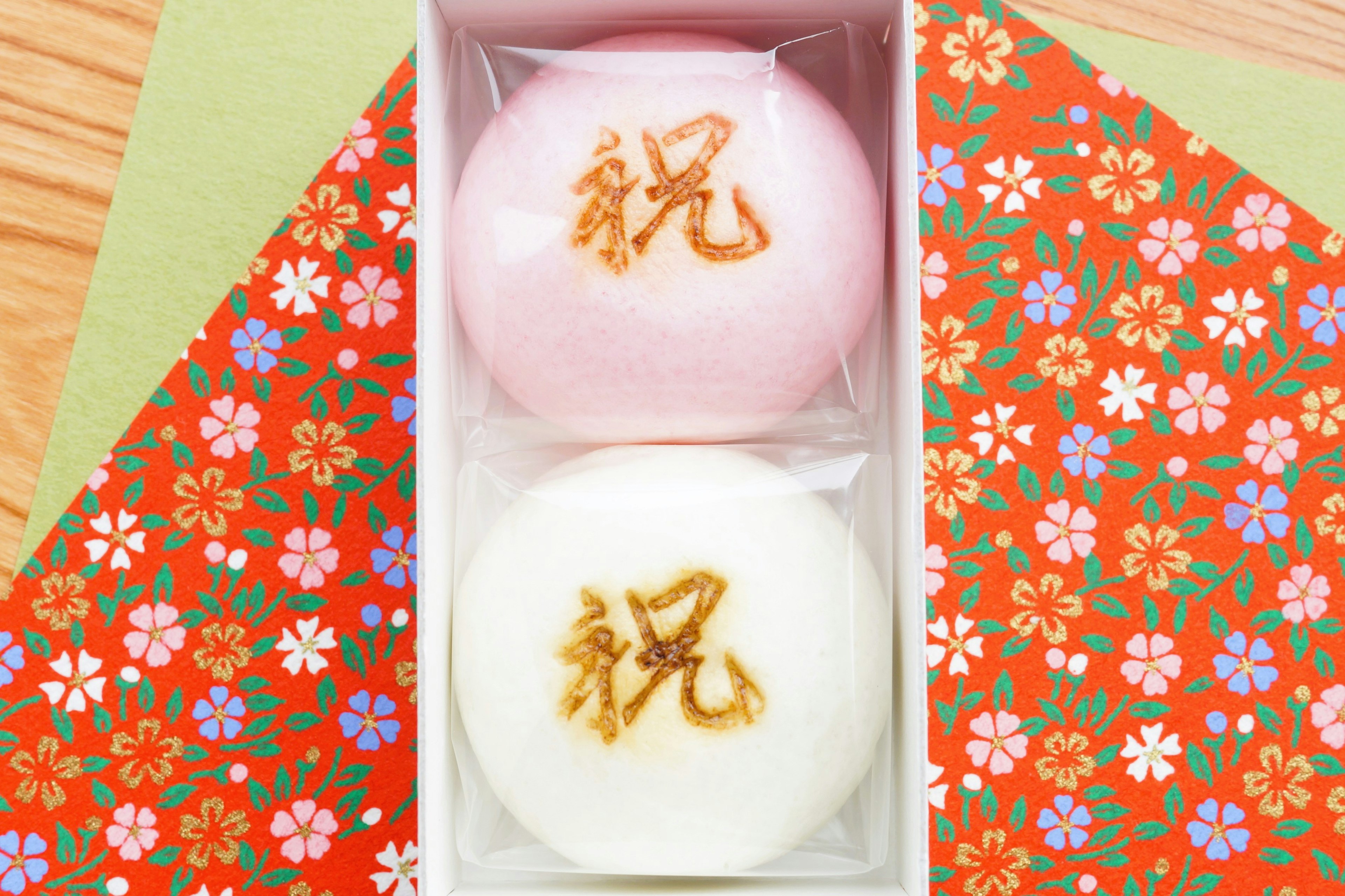 Pink and white steamed buns in a box floral patterned background