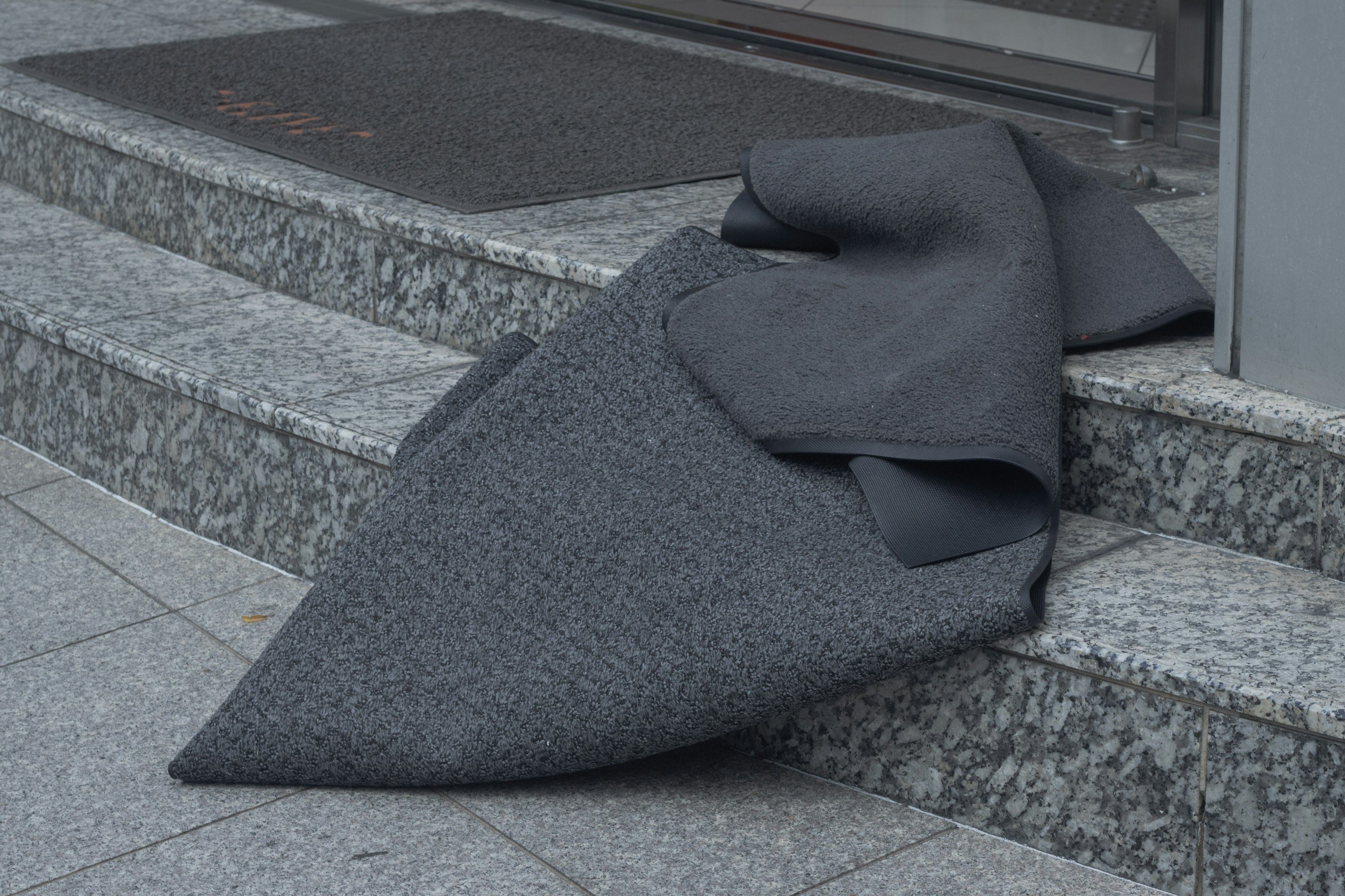 Gray fabric draped over steps at an entrance