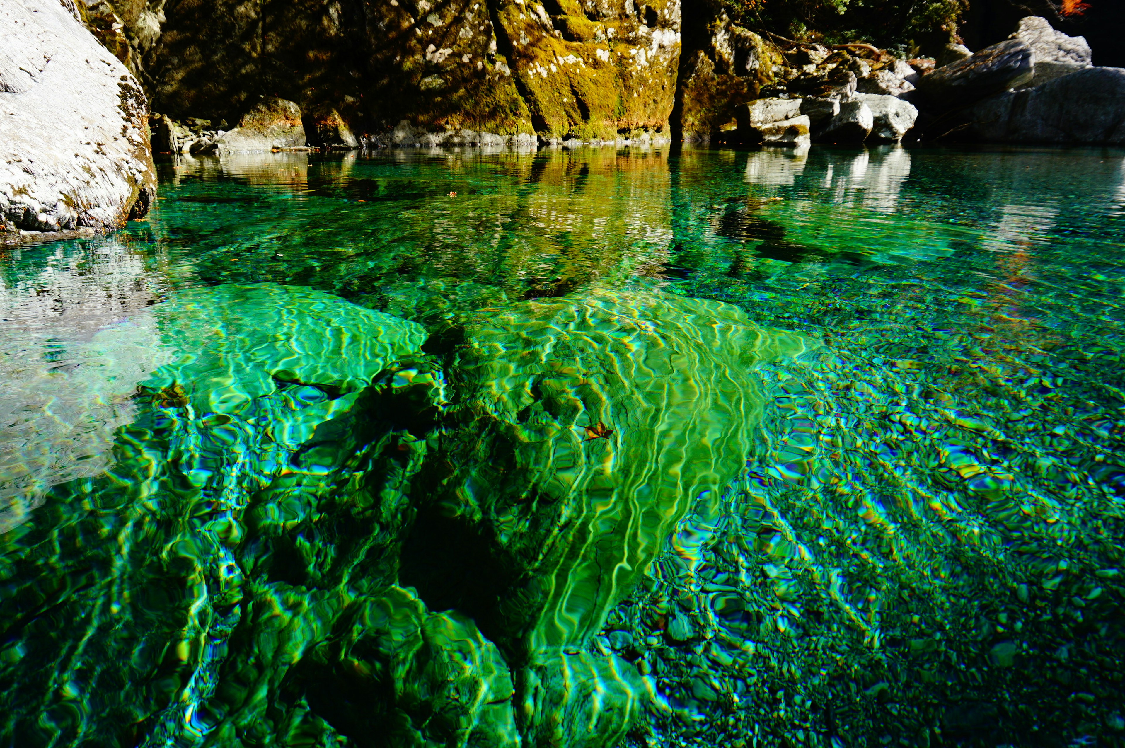 Beautiful water area with transparent green water and visible rocks