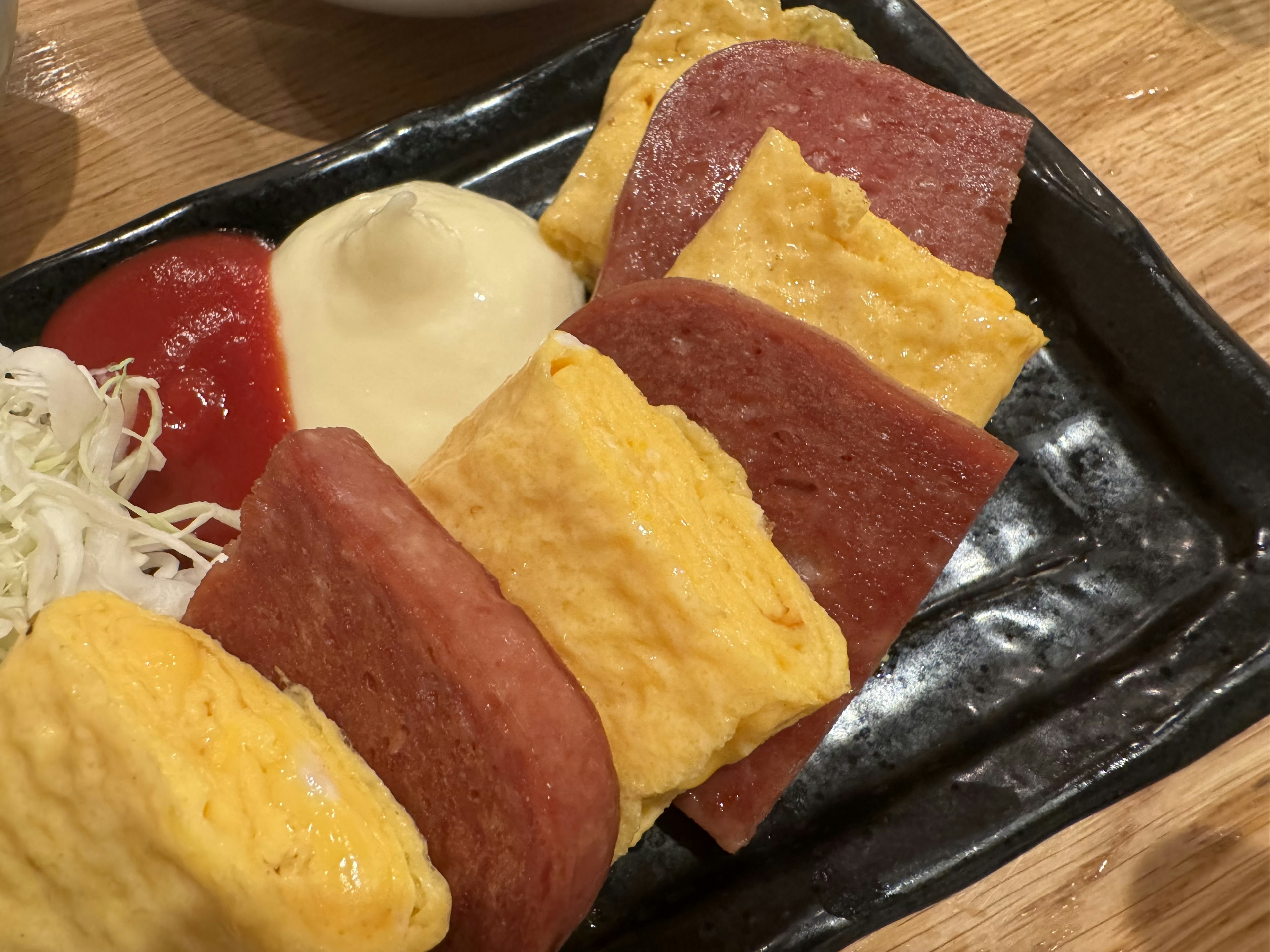 Colorful assortment of rolled omelette and ham