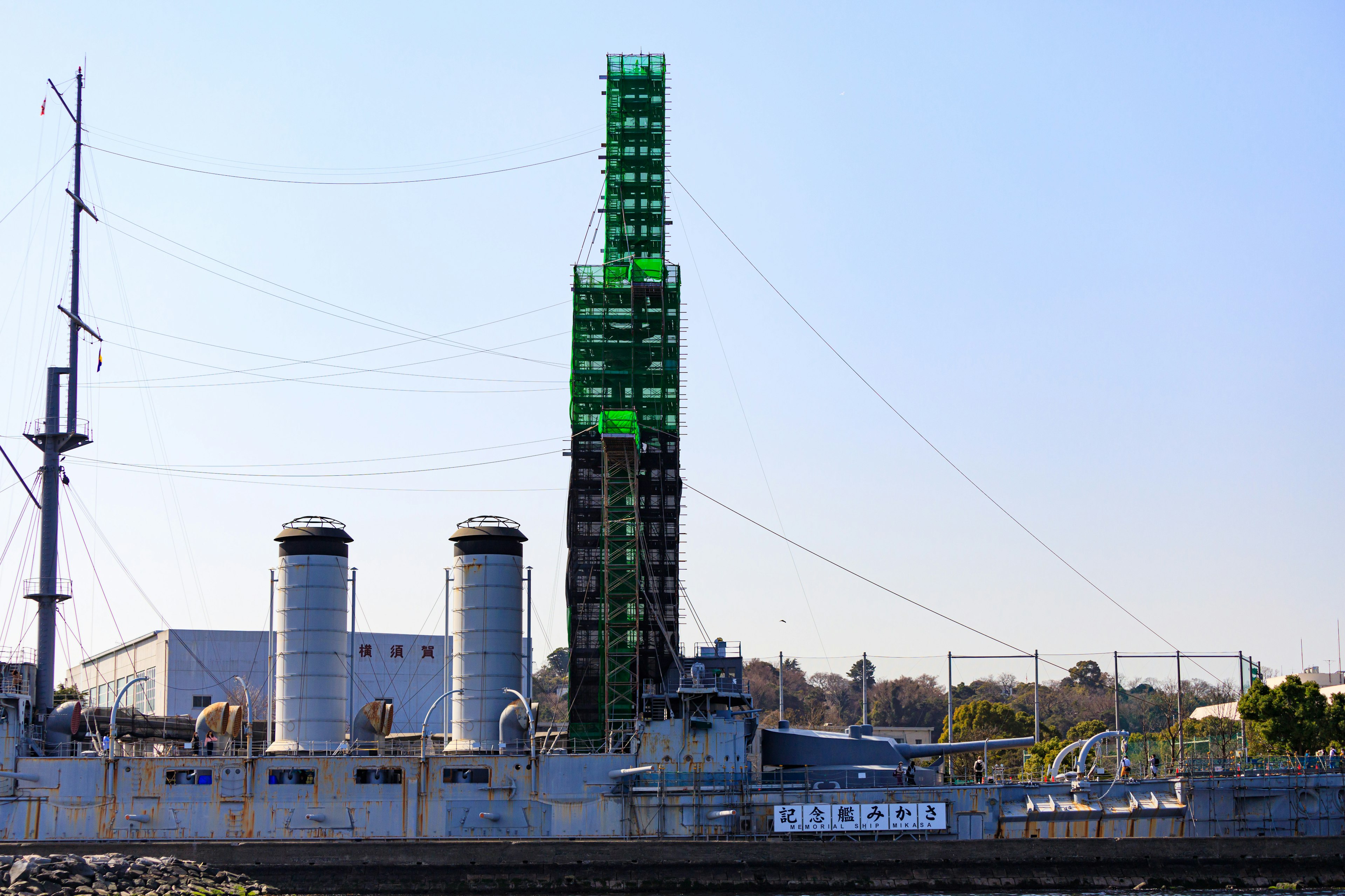 Side view of a ship featuring a green tower