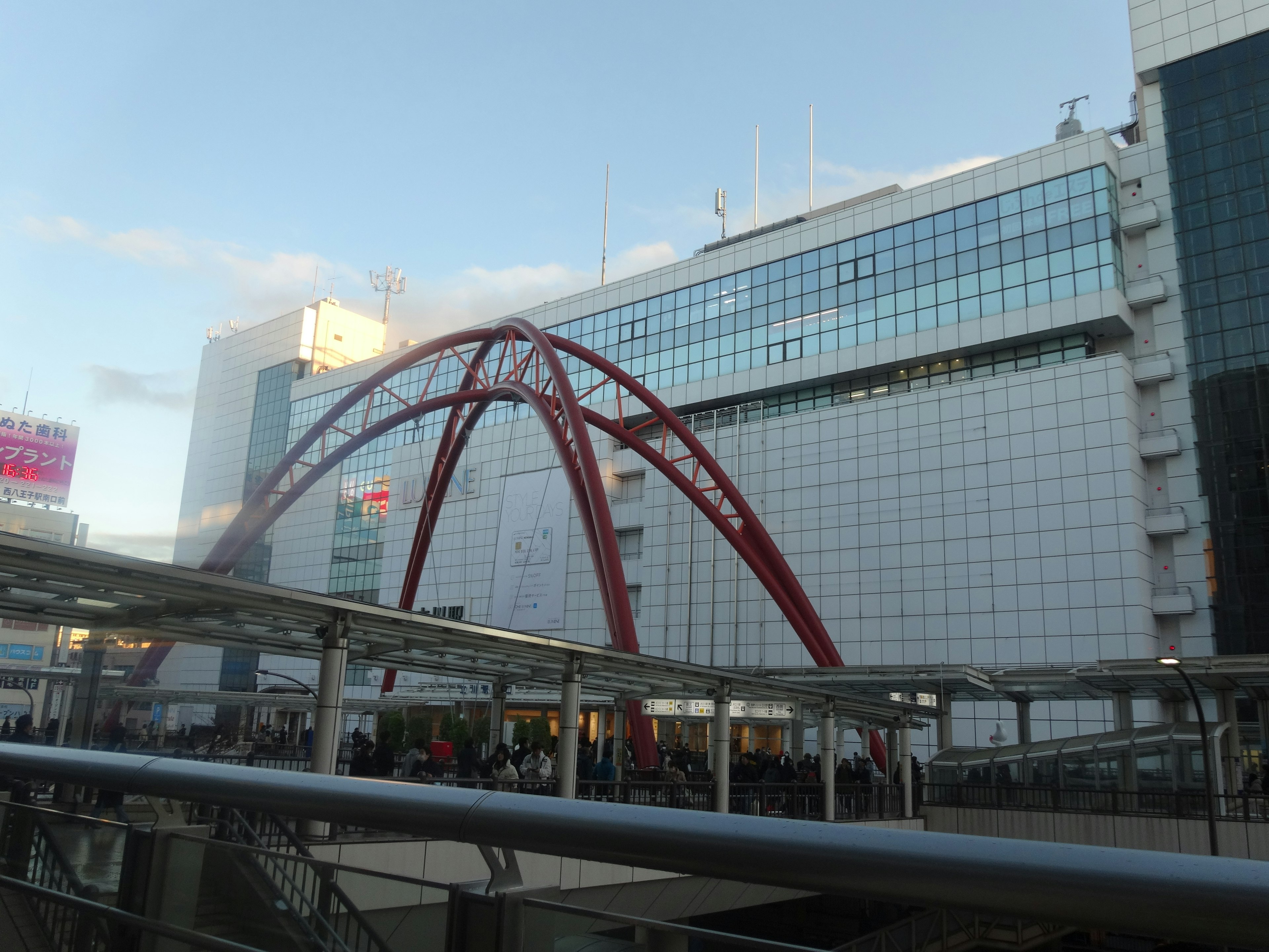 Red arch structure with modern building backdrop