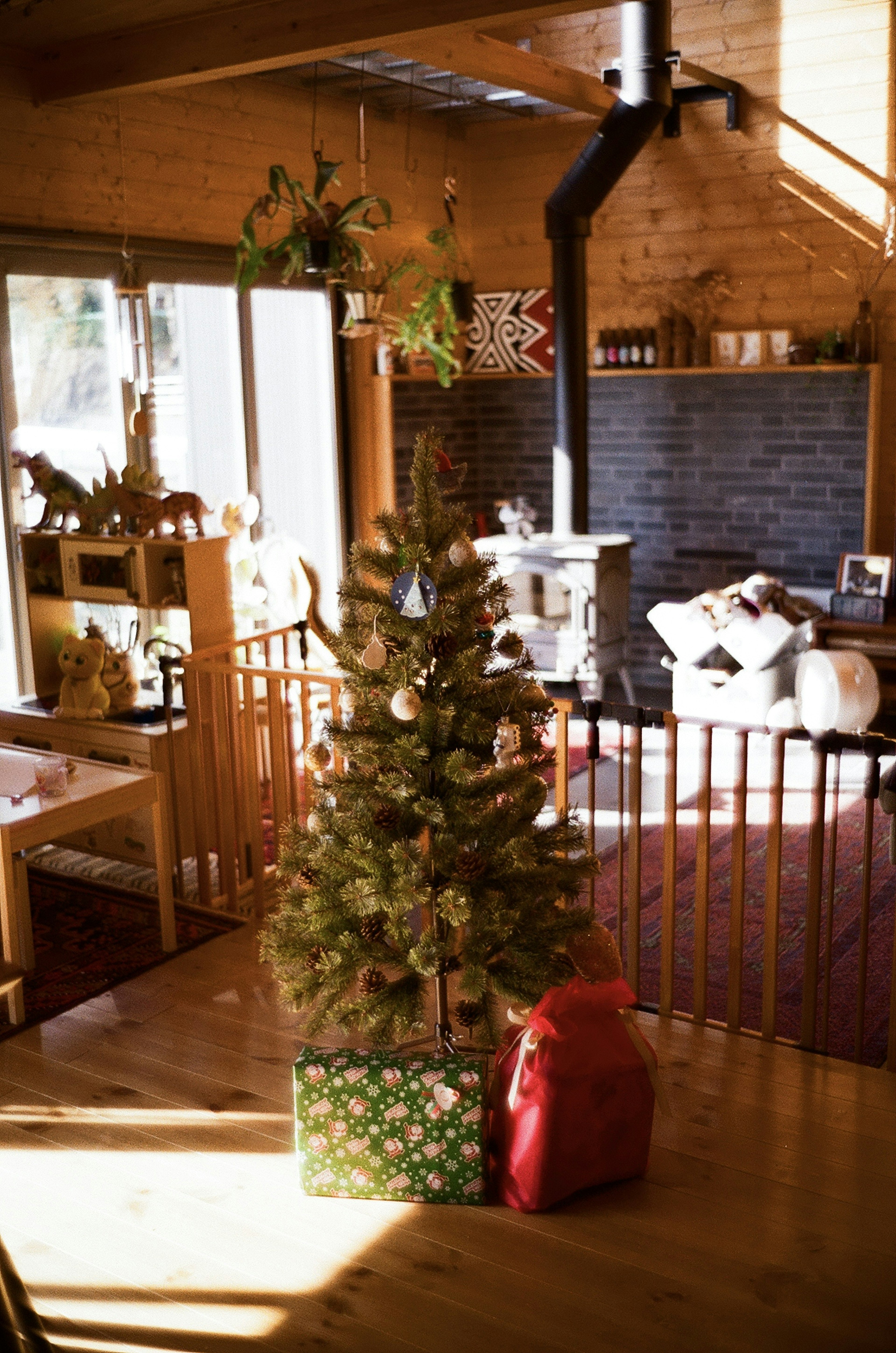 Cozy wooden interior with a Christmas tree and presents