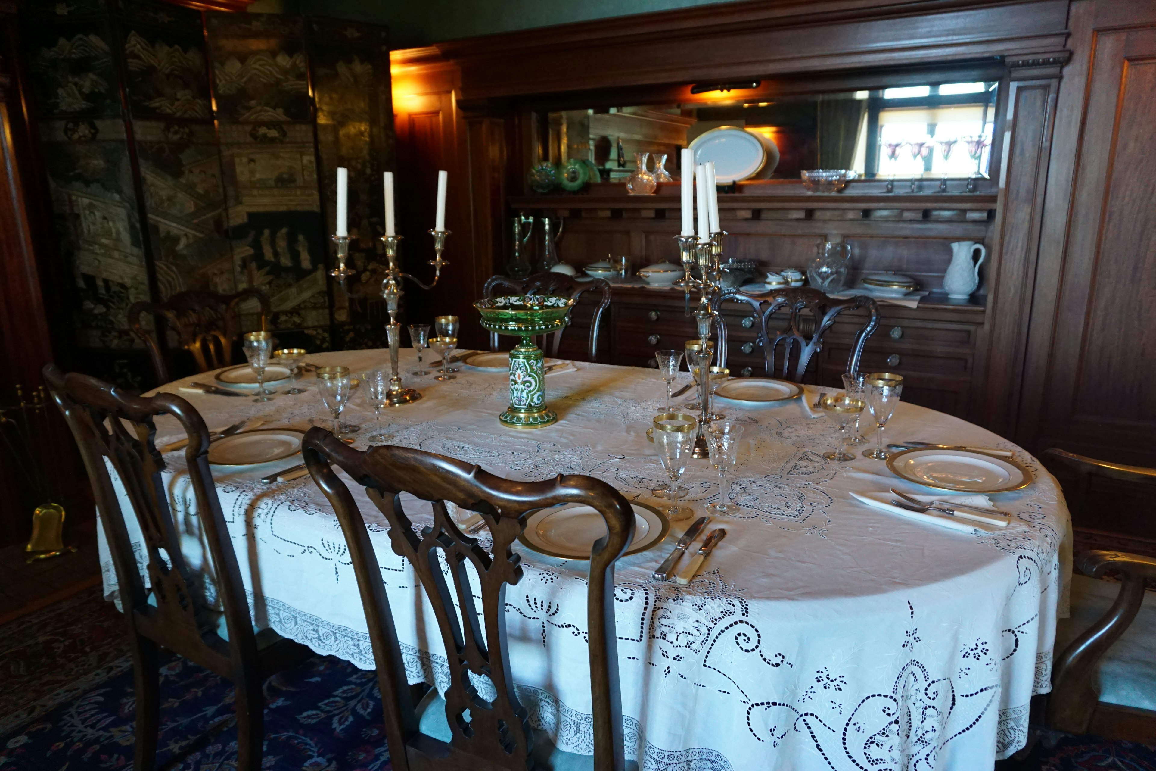 Elegant dining room featuring wooden furniture and candles