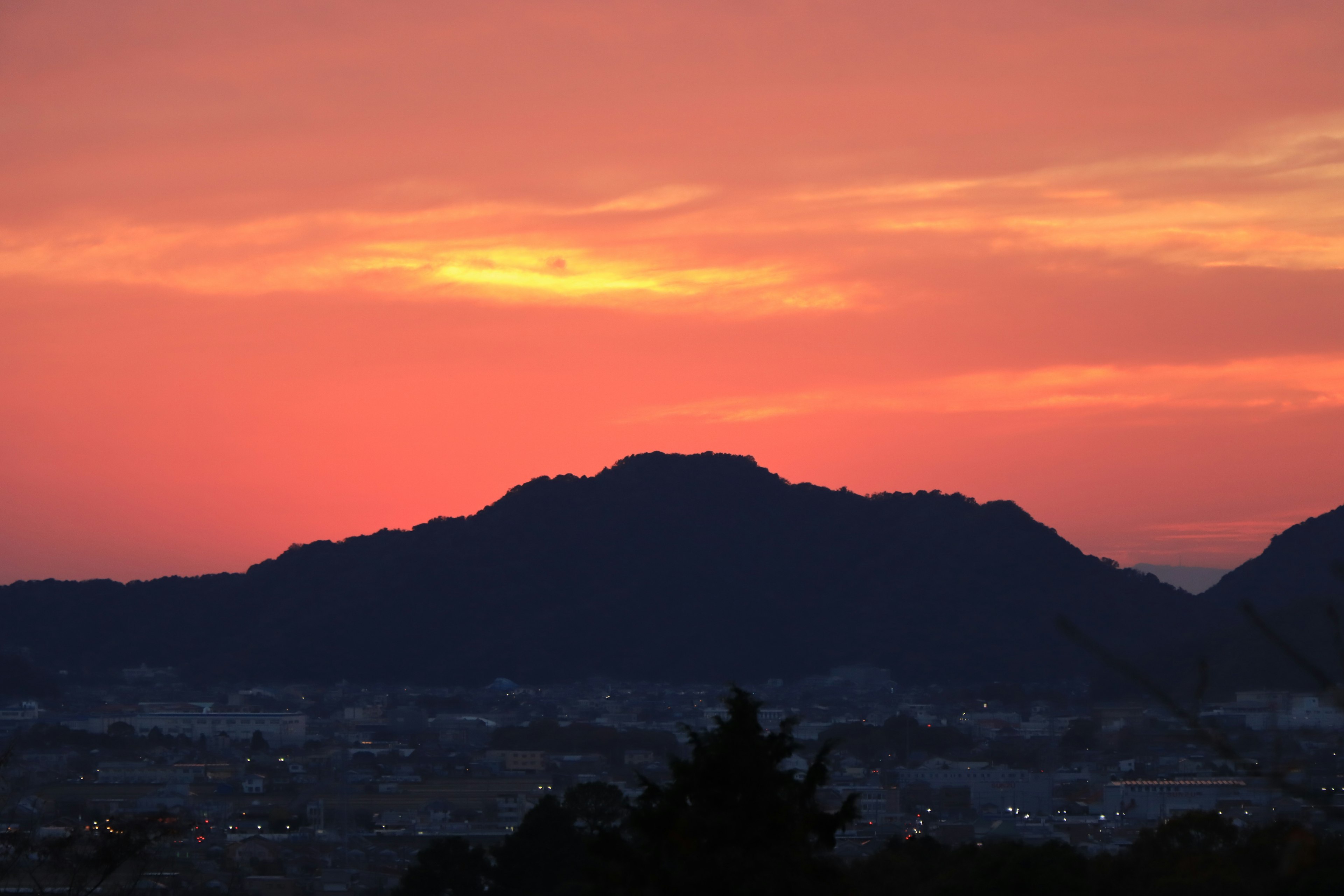 Silhouette of mountains against a vibrant sunset sky