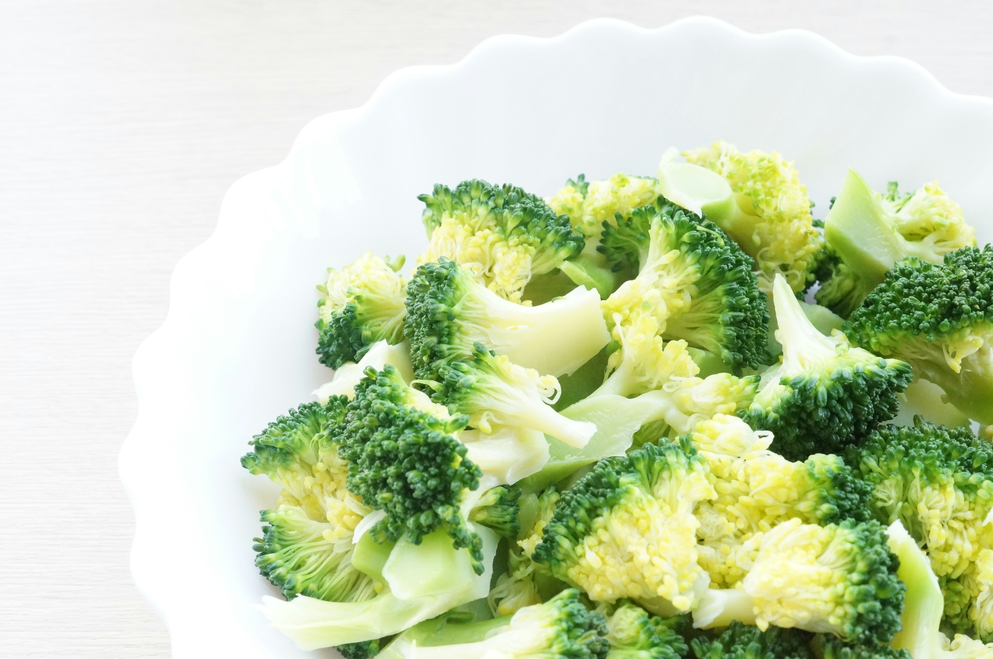 Close-up of fresh broccoli served in a white bowl