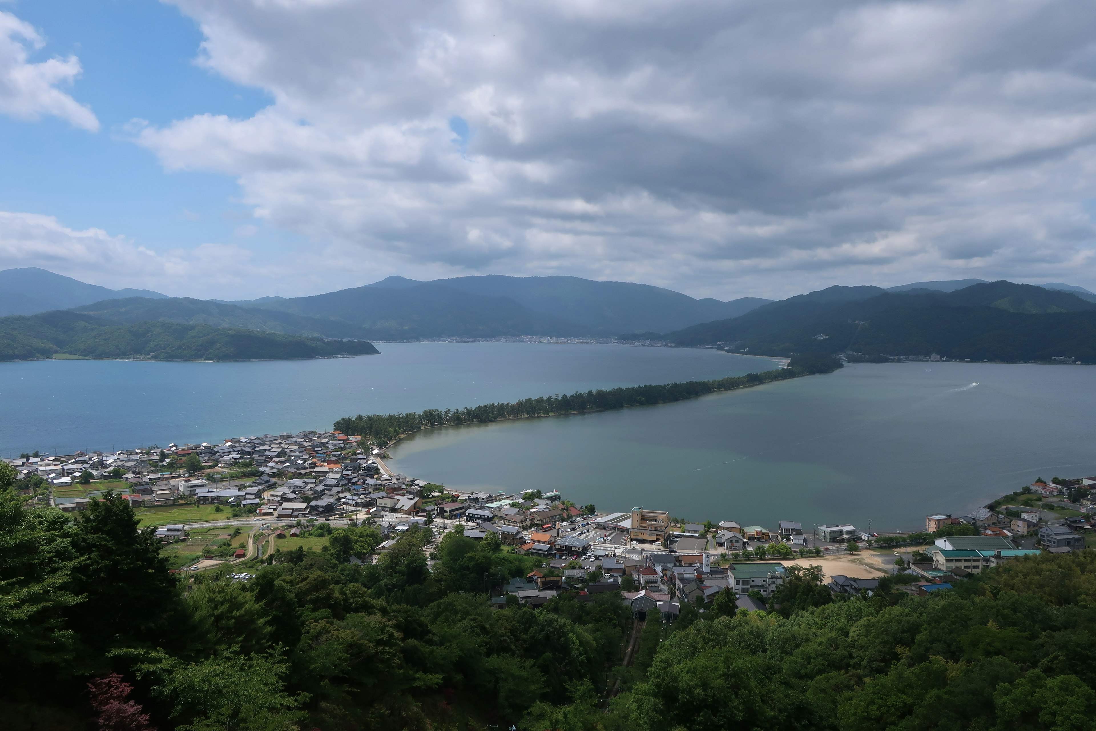 Pemandangan indah danau dan desa di antara perbukitan