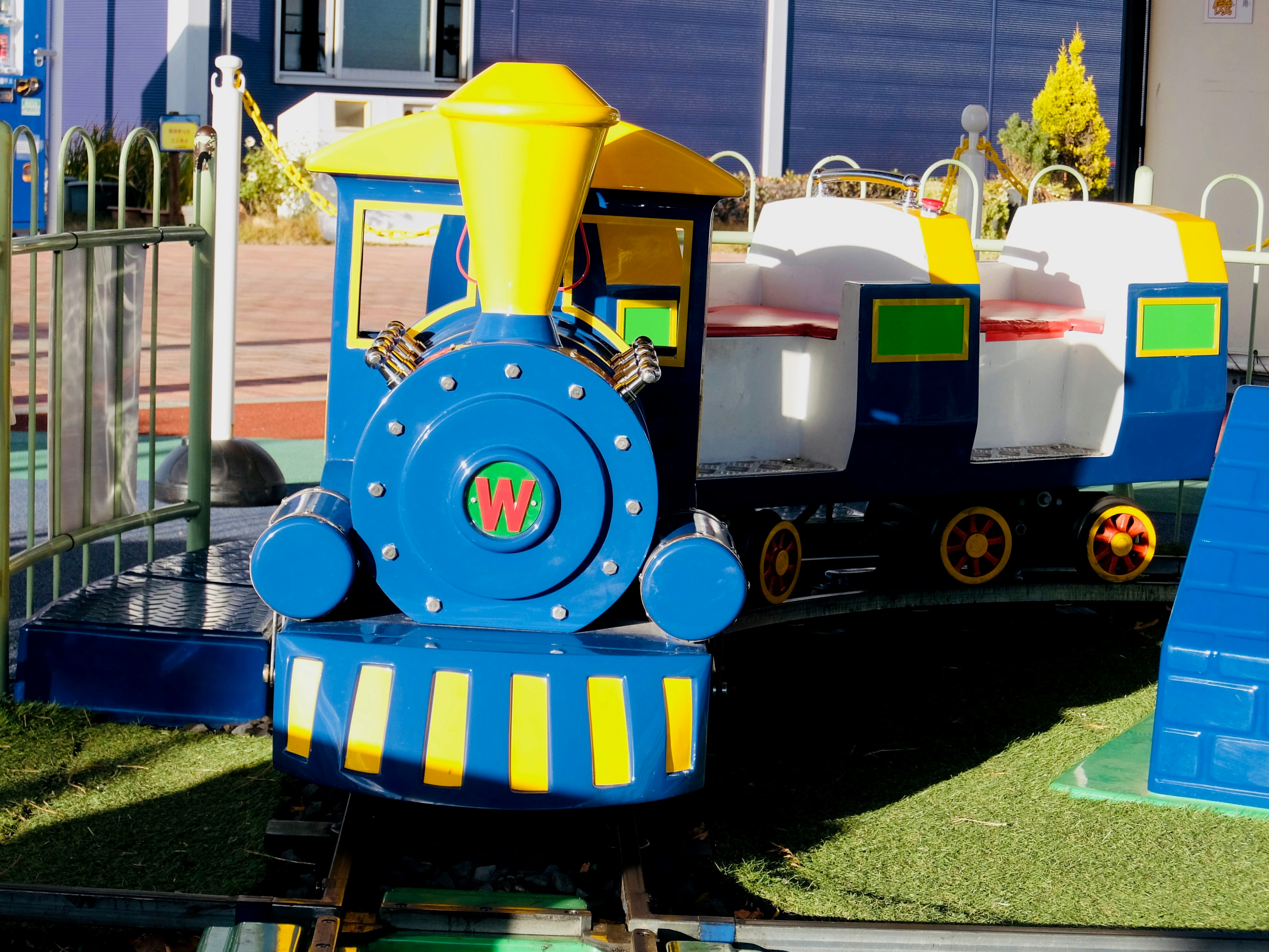 Tren colorido de parque infantil con diseño azul y amarillo