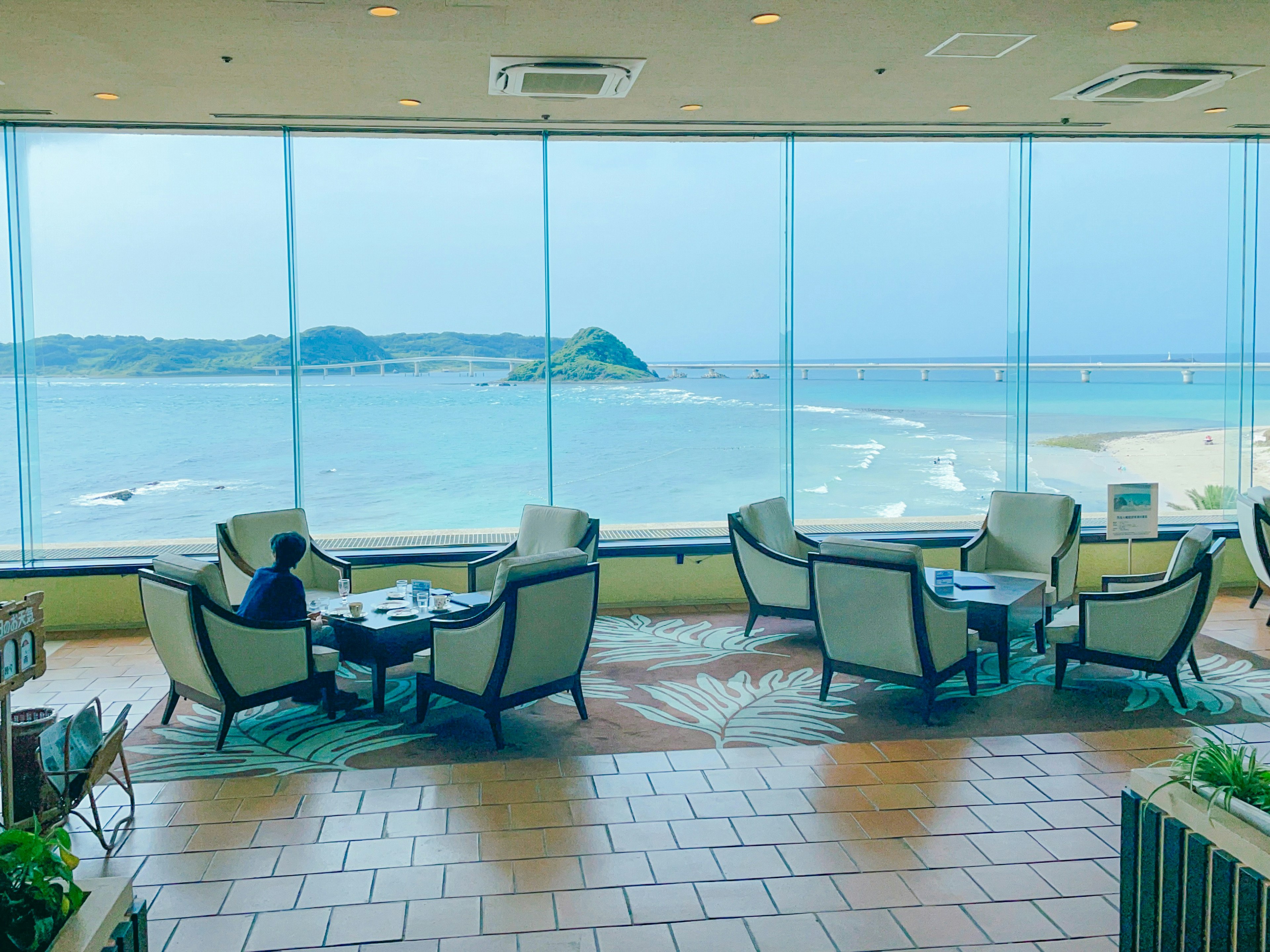 Lounge area with chairs and tables overlooking the sea view