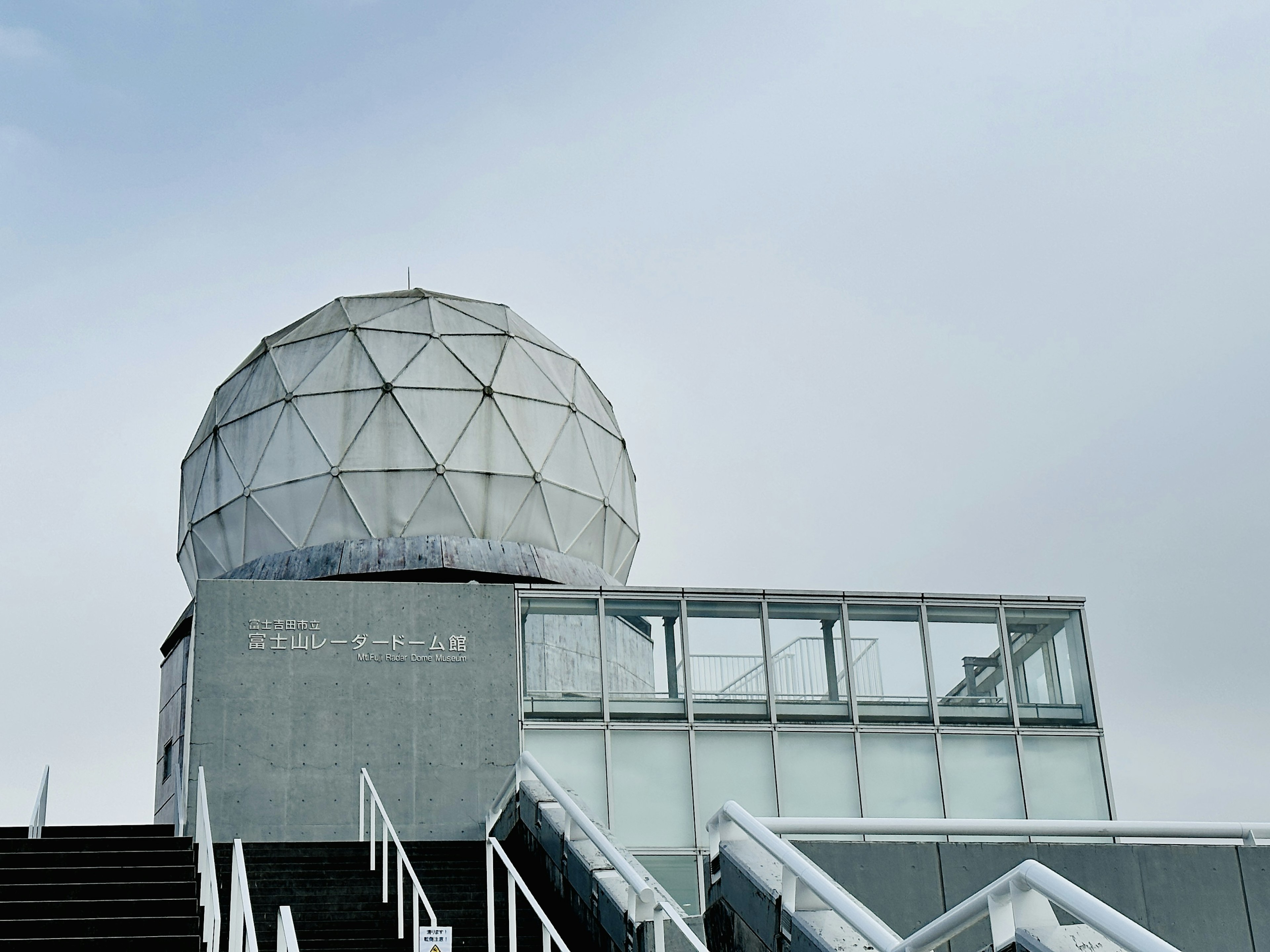 Photo d'un bâtiment moderne avec un dôme blanc et des murs en verre