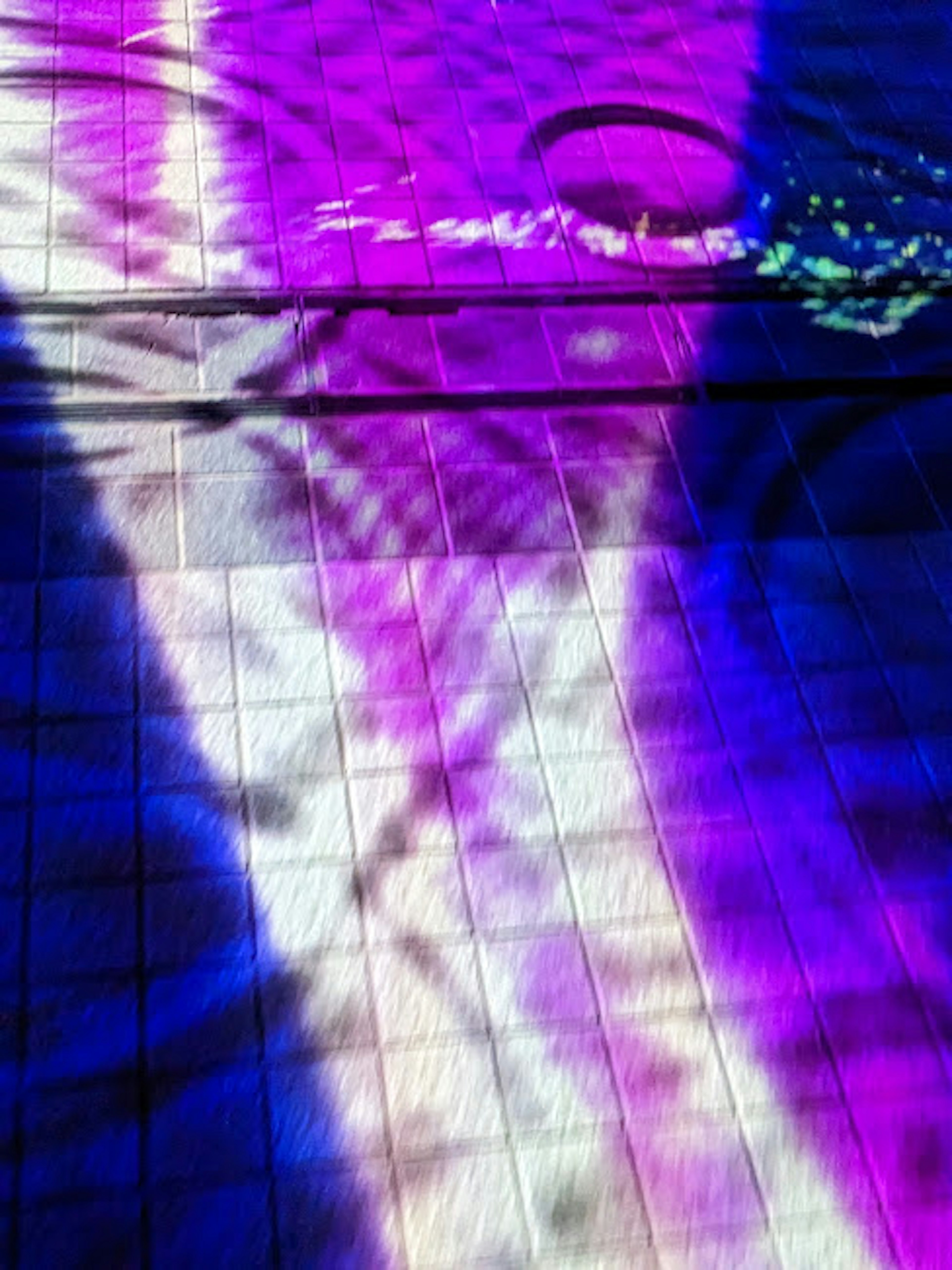 Abstract pattern of purple and blue light reflecting on water surface