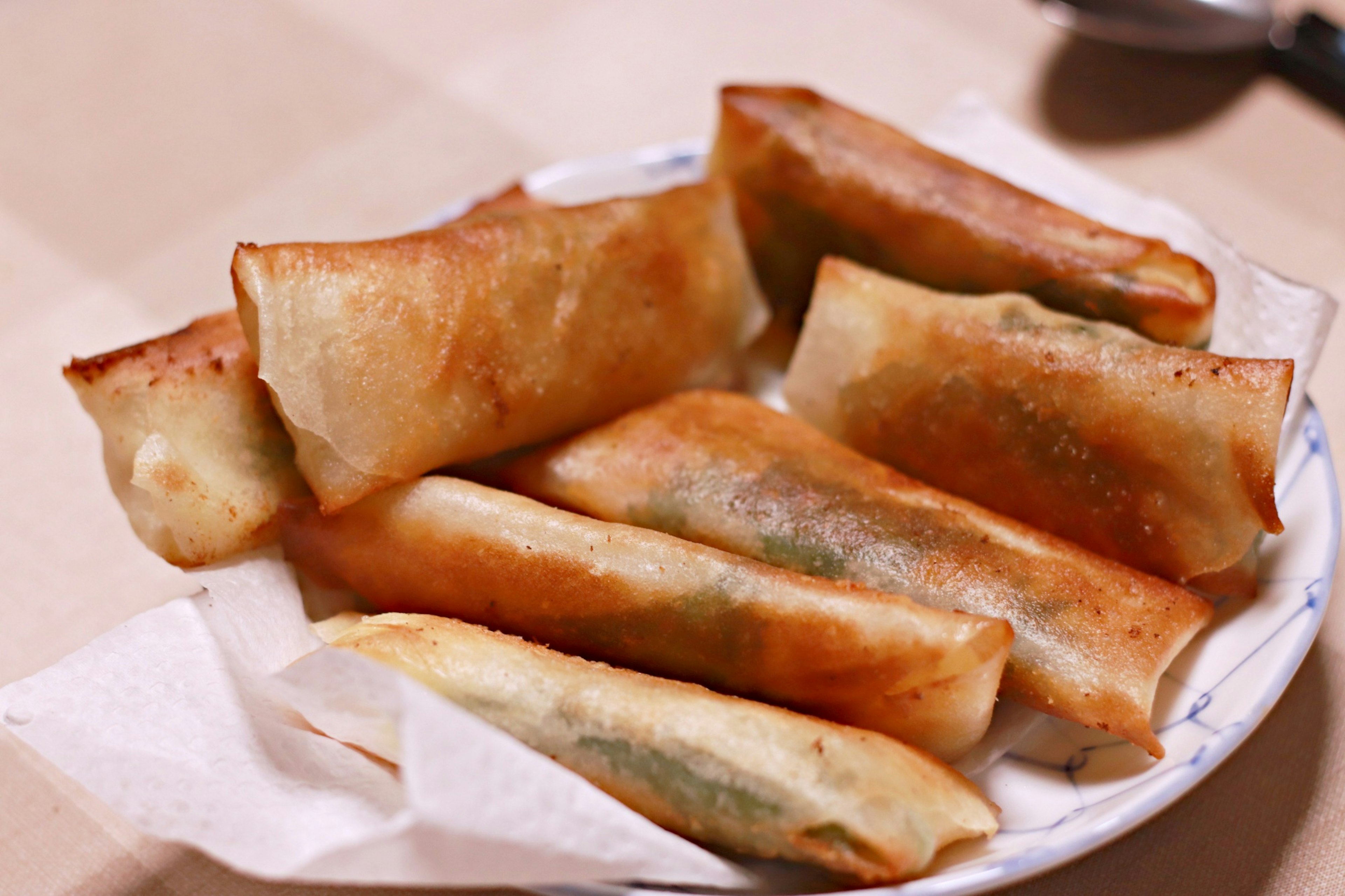 A plate of crispy spring rolls arranged neatly