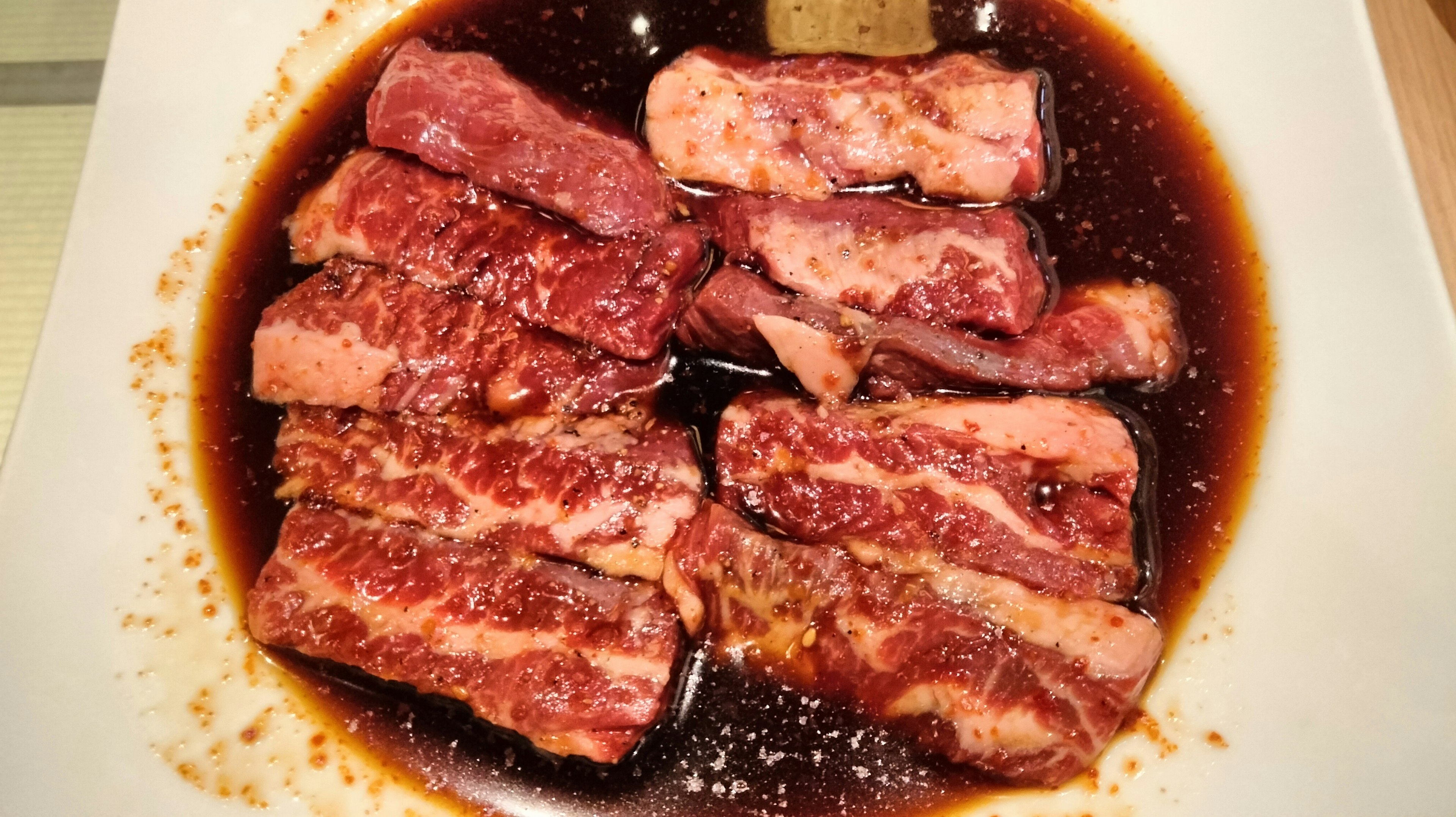 Slices of marinated meat arranged on a plate