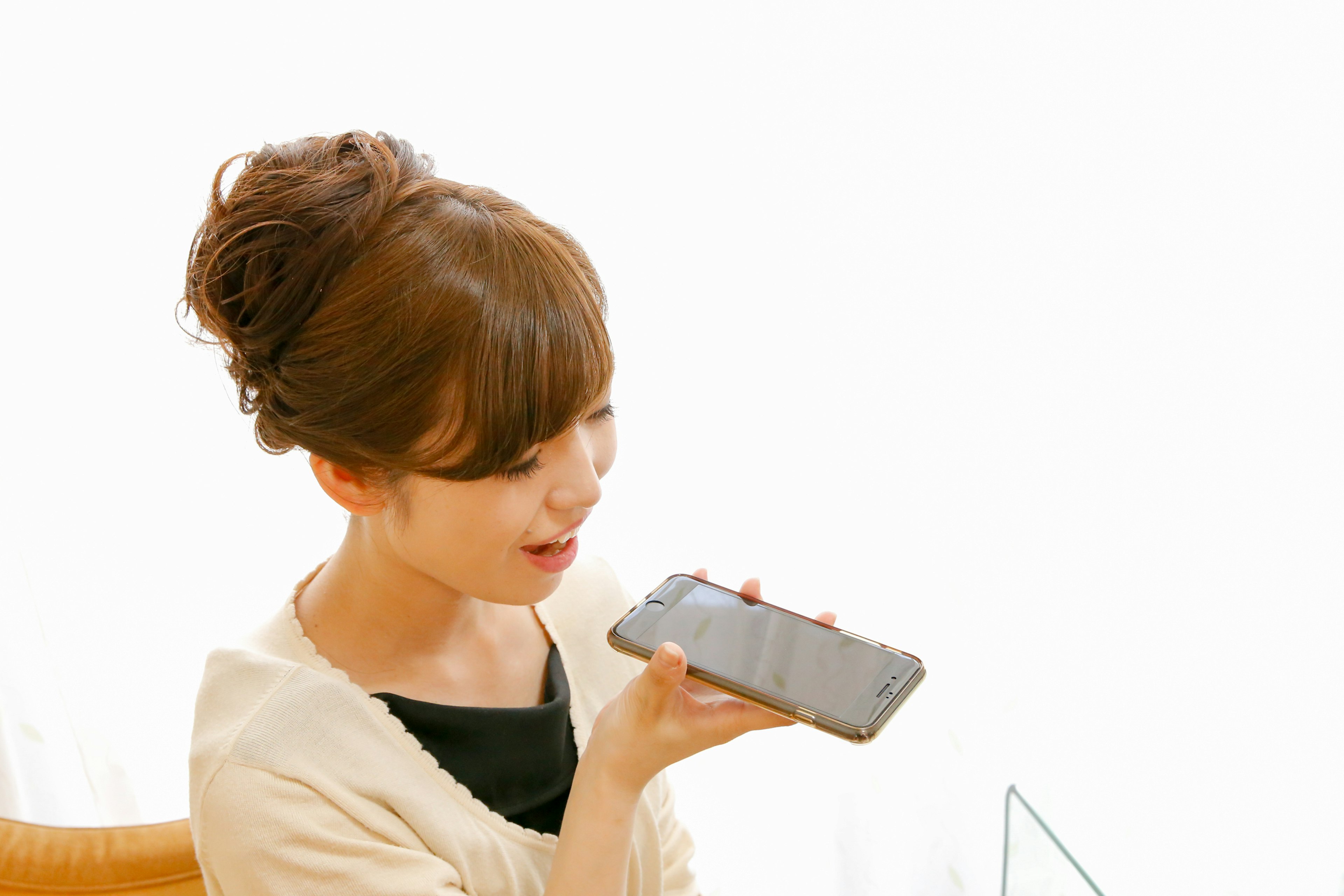 A woman speaking into a smartphone