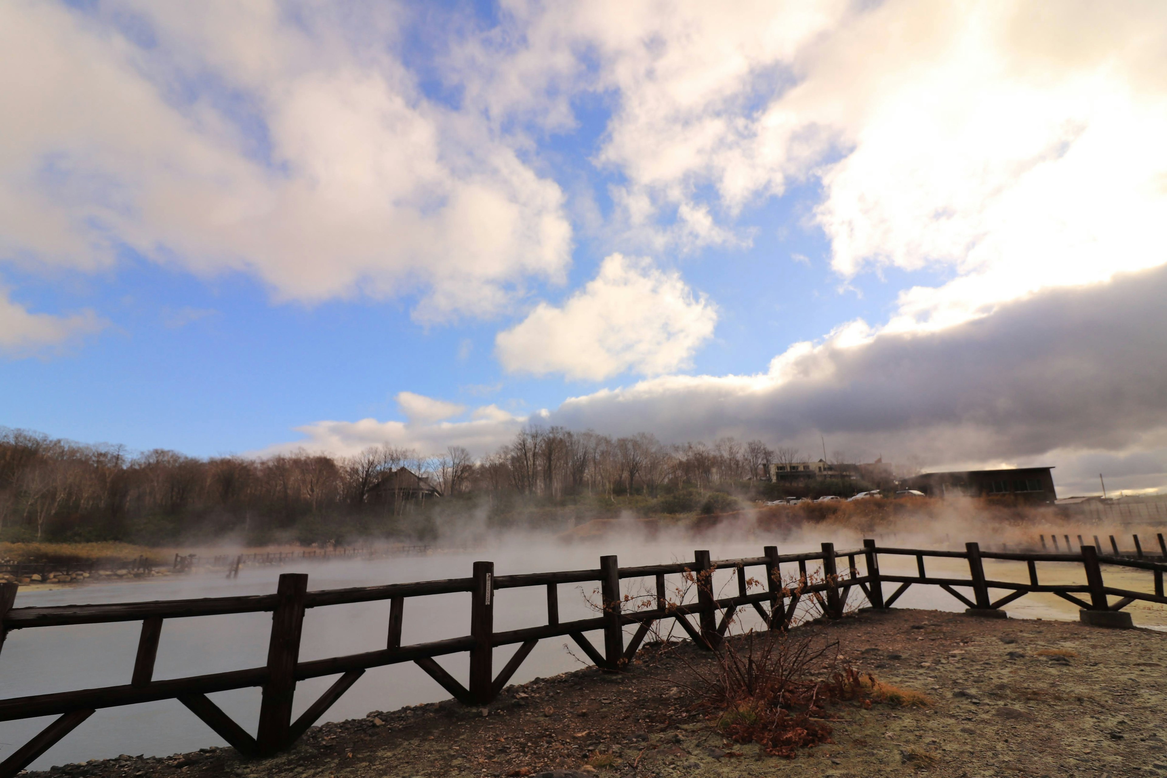 Vue panoramique d'une rivière brumeuse avec un pont en bois