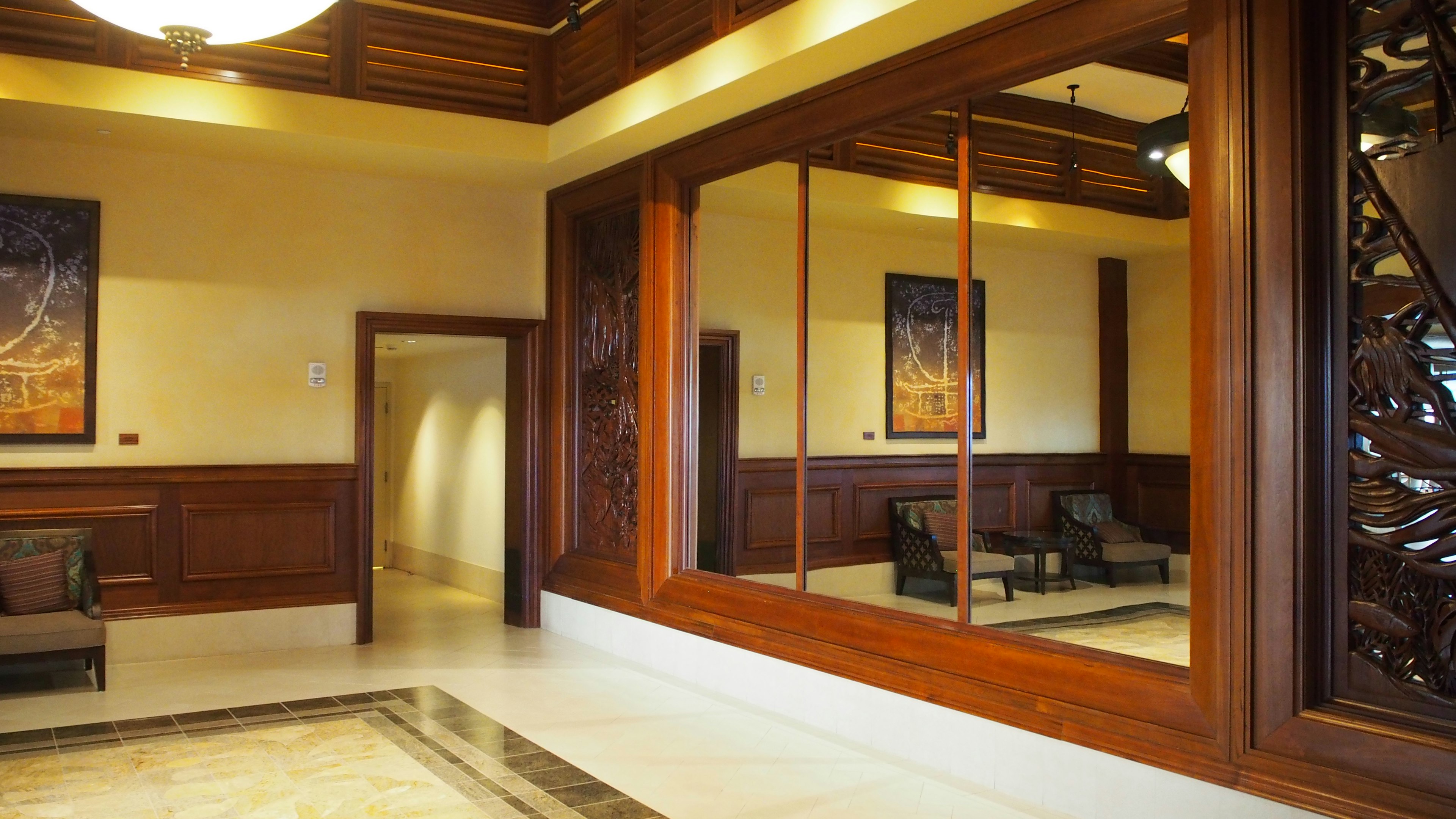 Luxurious living room interior featuring wooden decor and large mirrors