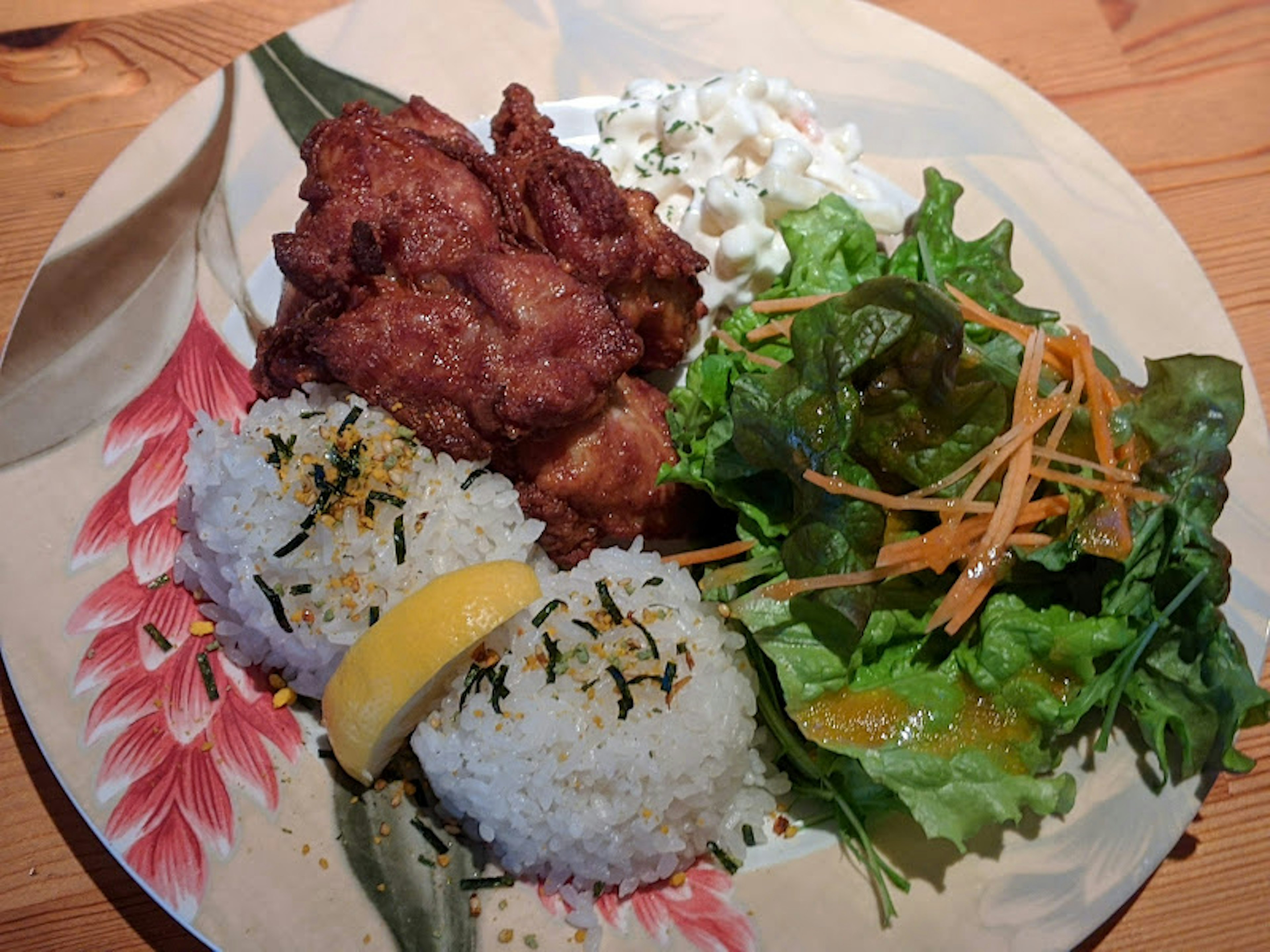 Plate featuring white rice, fried chicken, and a salad