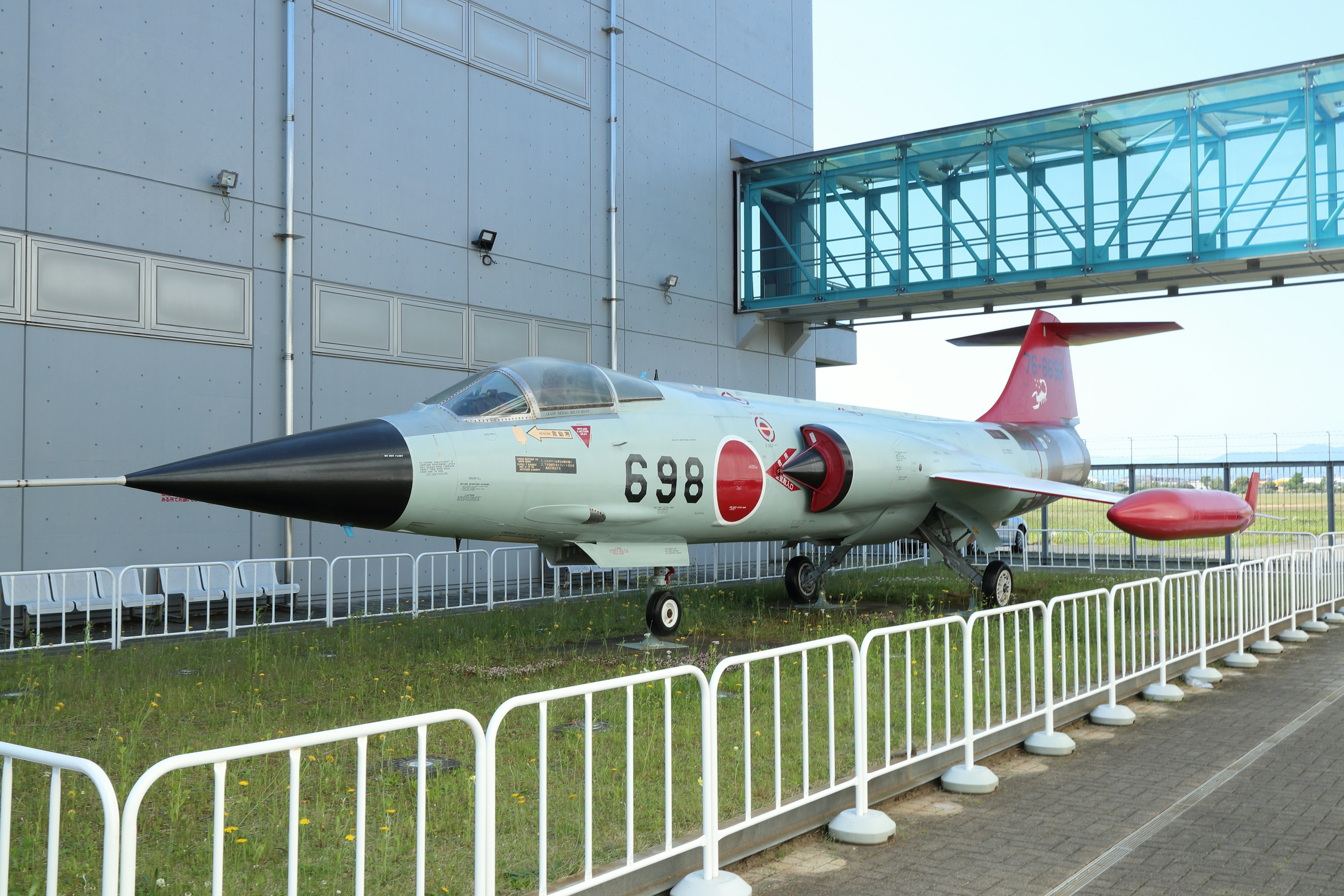 A military aircraft displayed outside a building