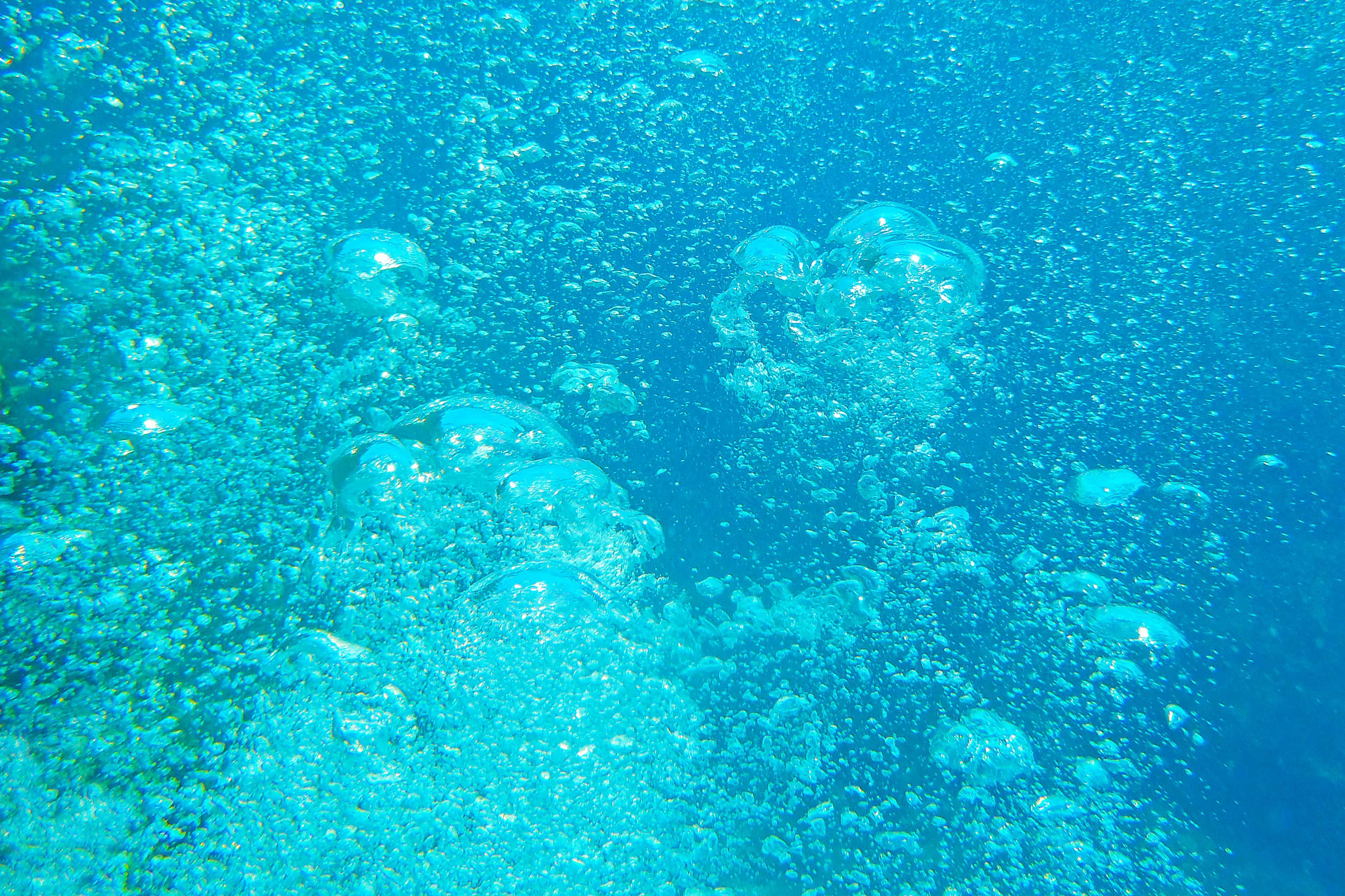 Bubbles rising in a blue underwater scene