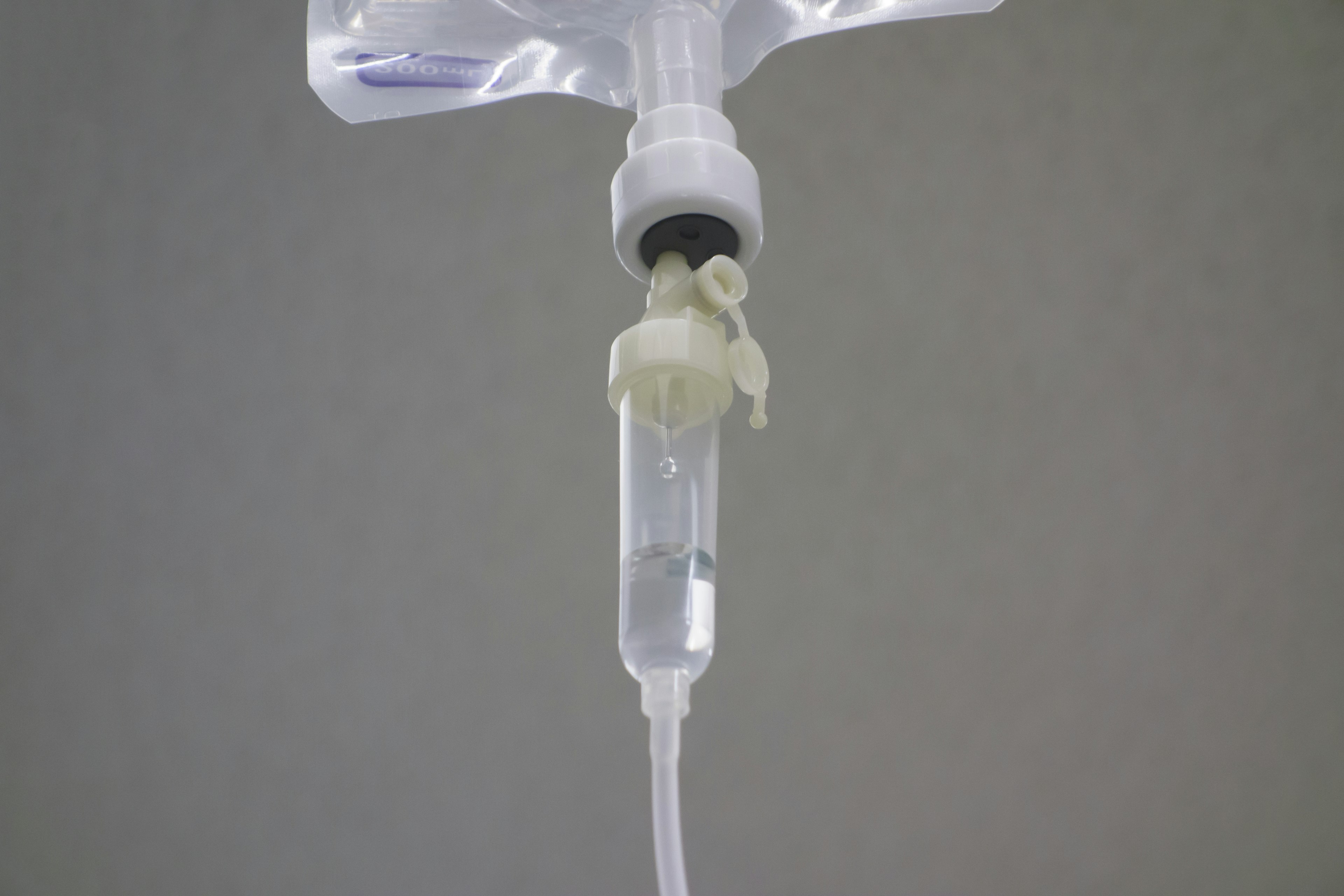 IV drip system with clear tubing and liquid container