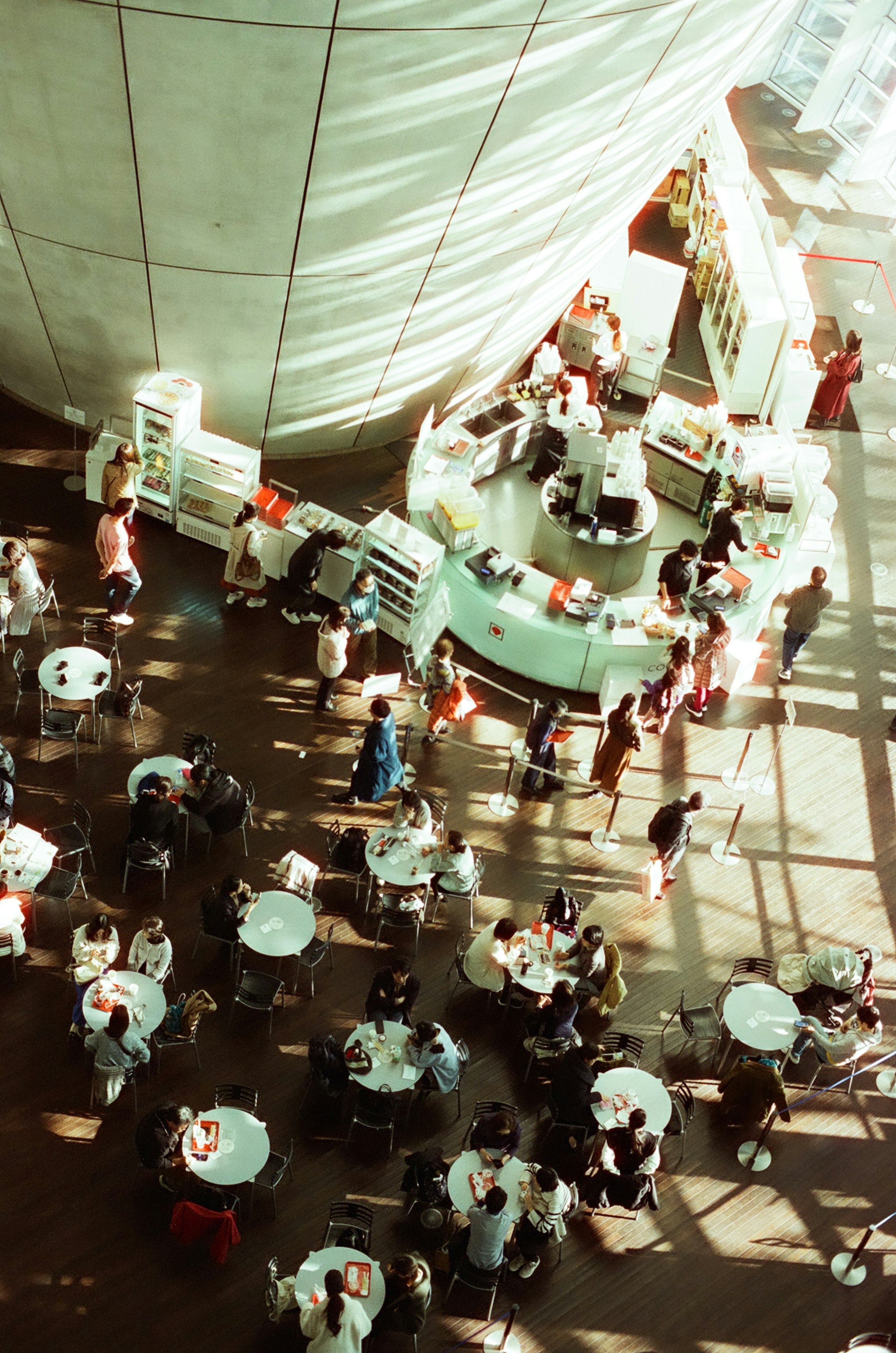 An aerial view of a café with tables and people gathering in an elegant space