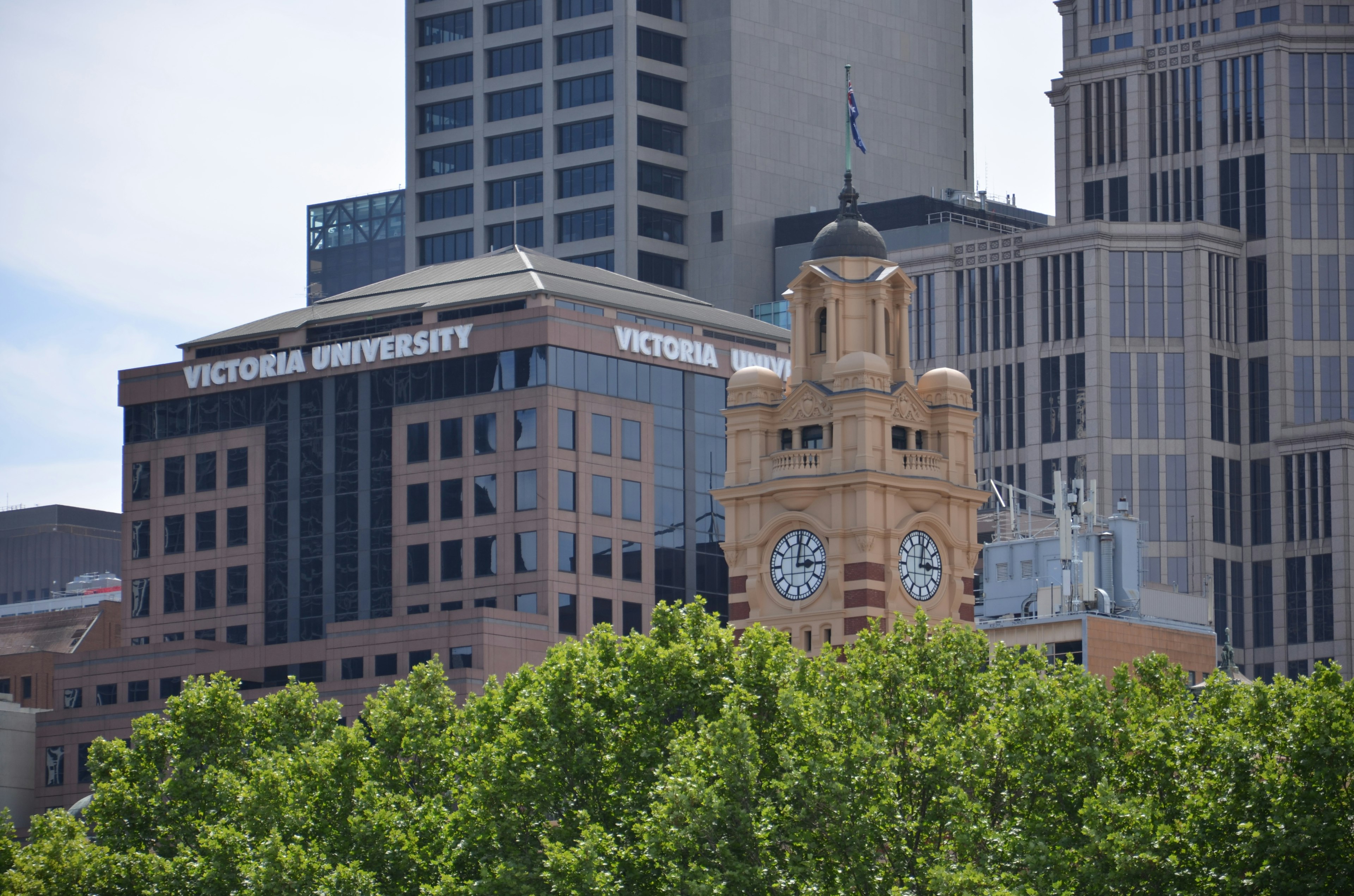 Urban landscape featuring Victoria University signage and a clock tower