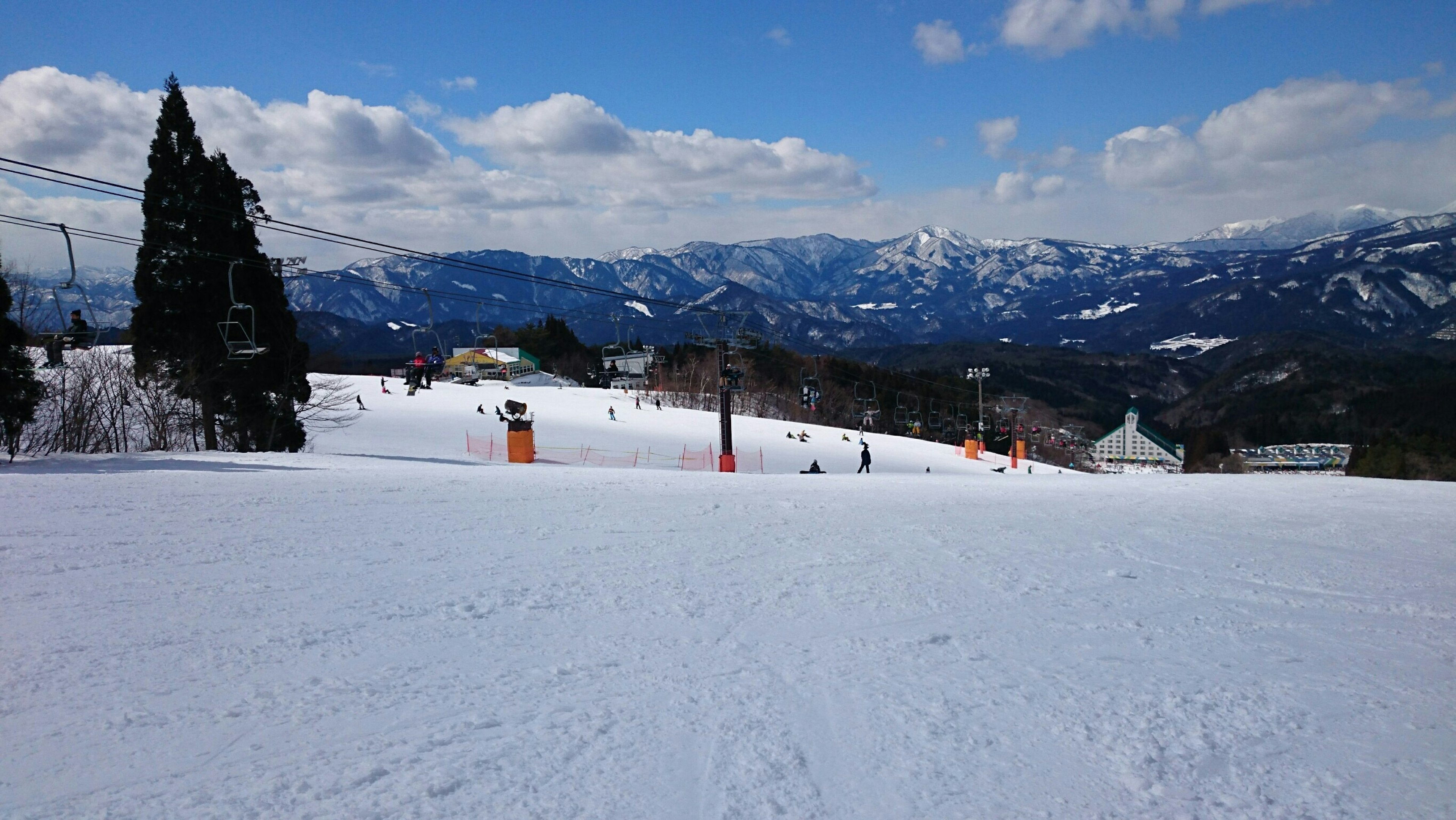 Snow-covered ski resort with mountains in the background