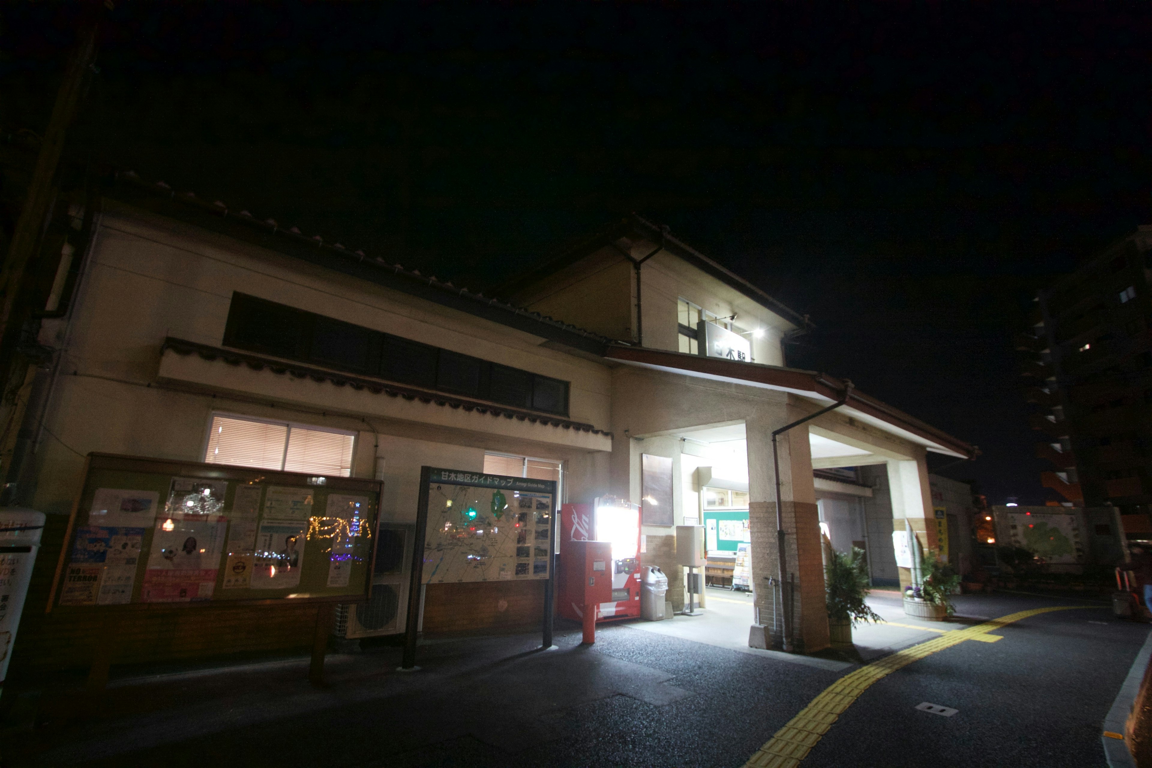 Exterior of a Japanese building at night on a street corner