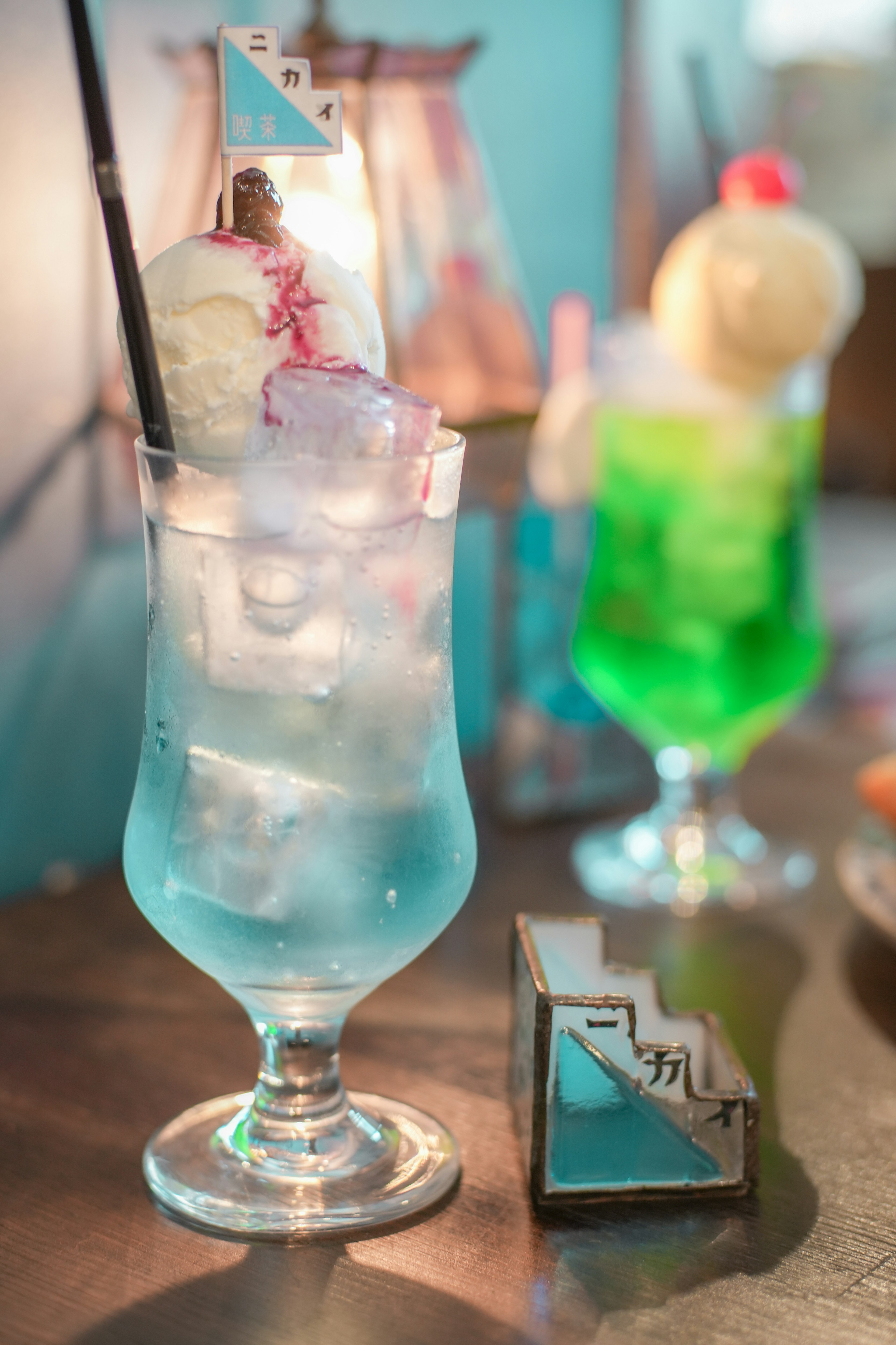 A photo of a blue cocktail with ice and ice cream in a glass