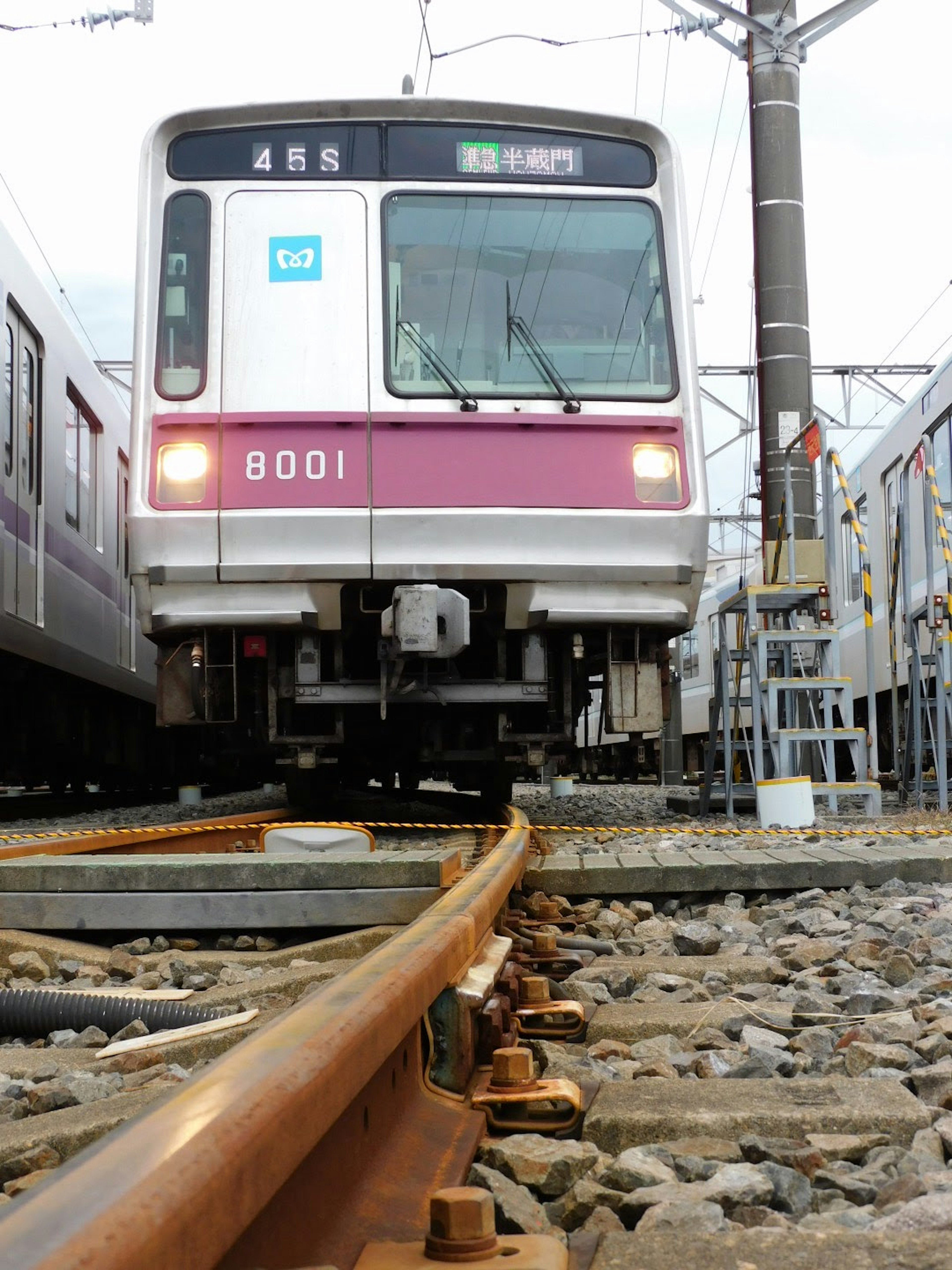 Photo from the perspective of train tracks showing the front of a train