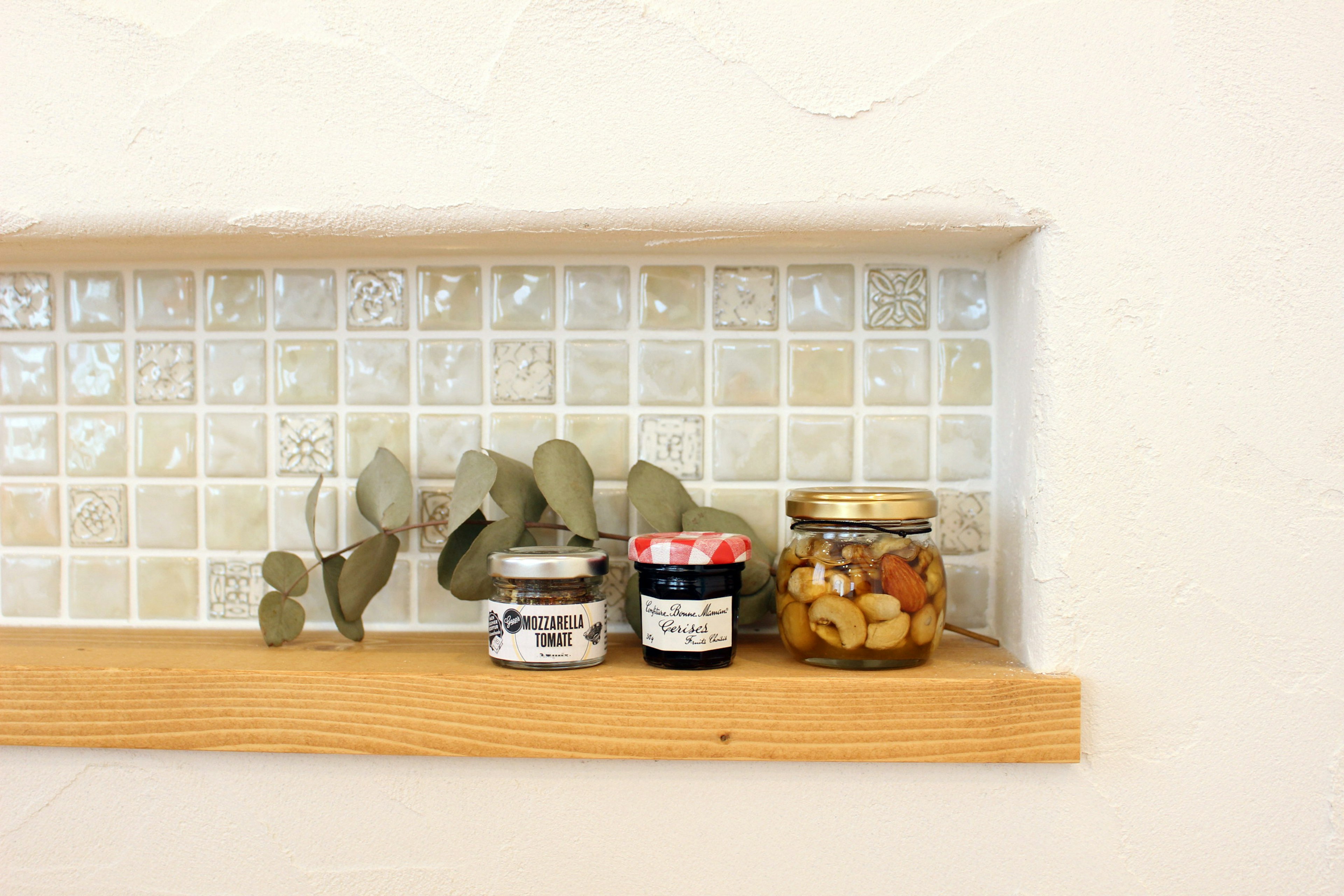 Display of small jars and plants on a shelf