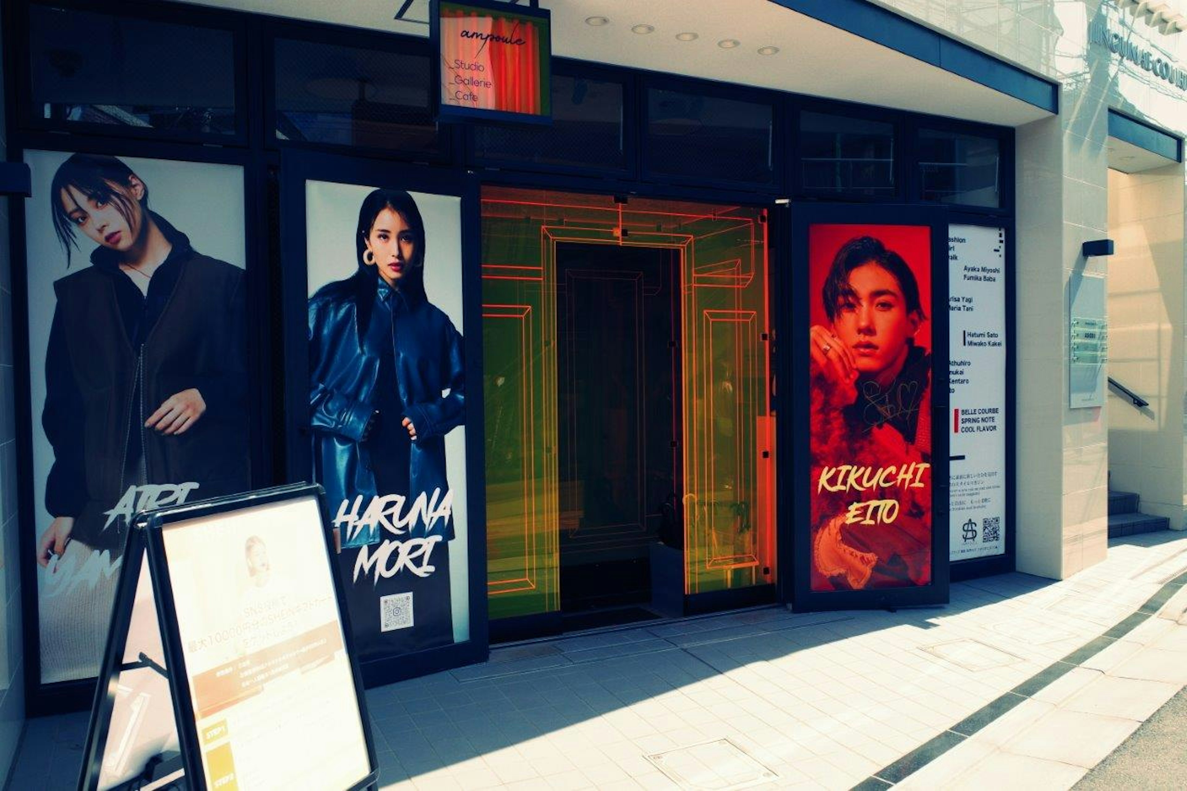 The storefront features large posters of models with vibrant designs