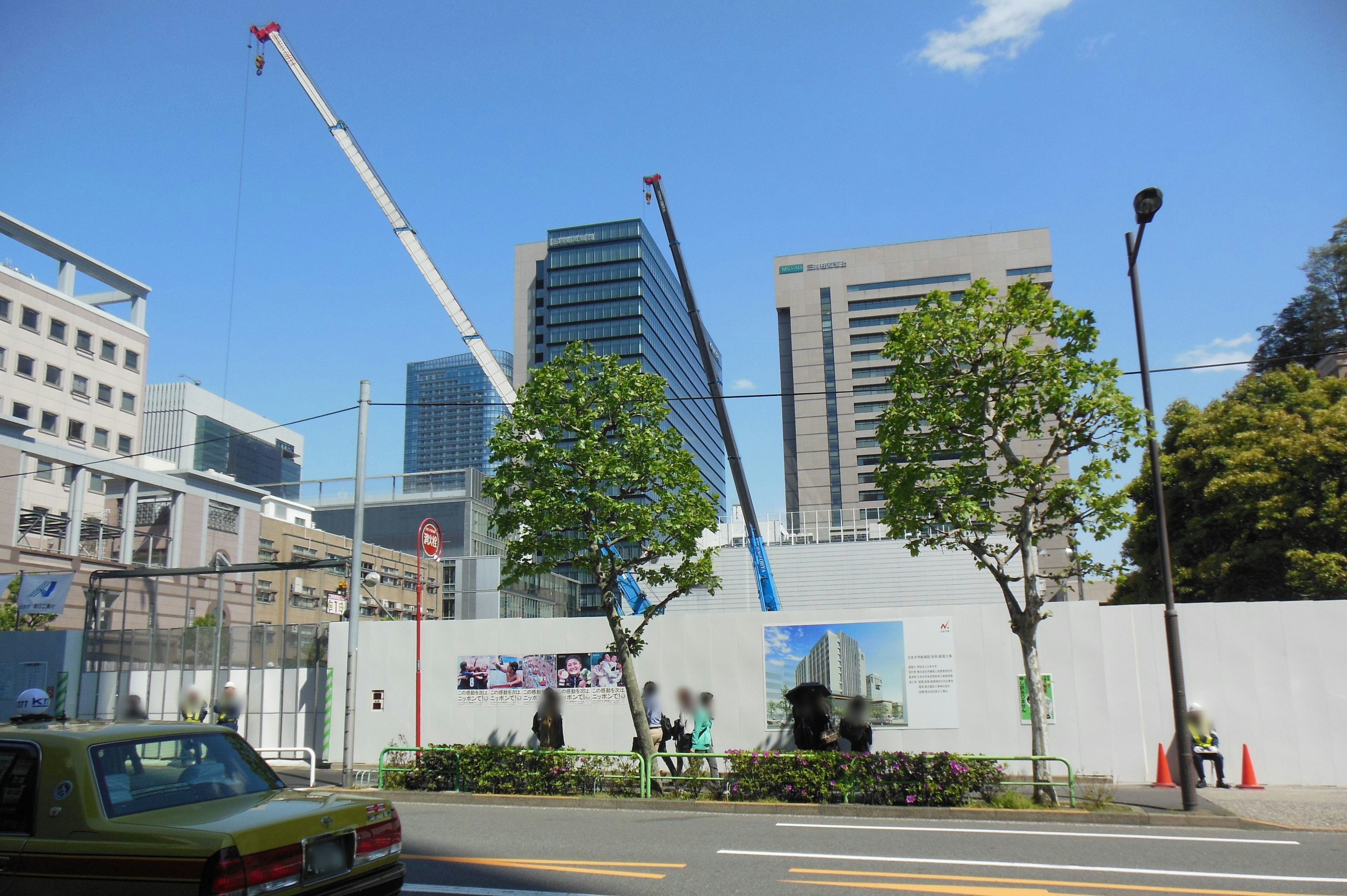 Urban scene featuring skyscrapers and cranes