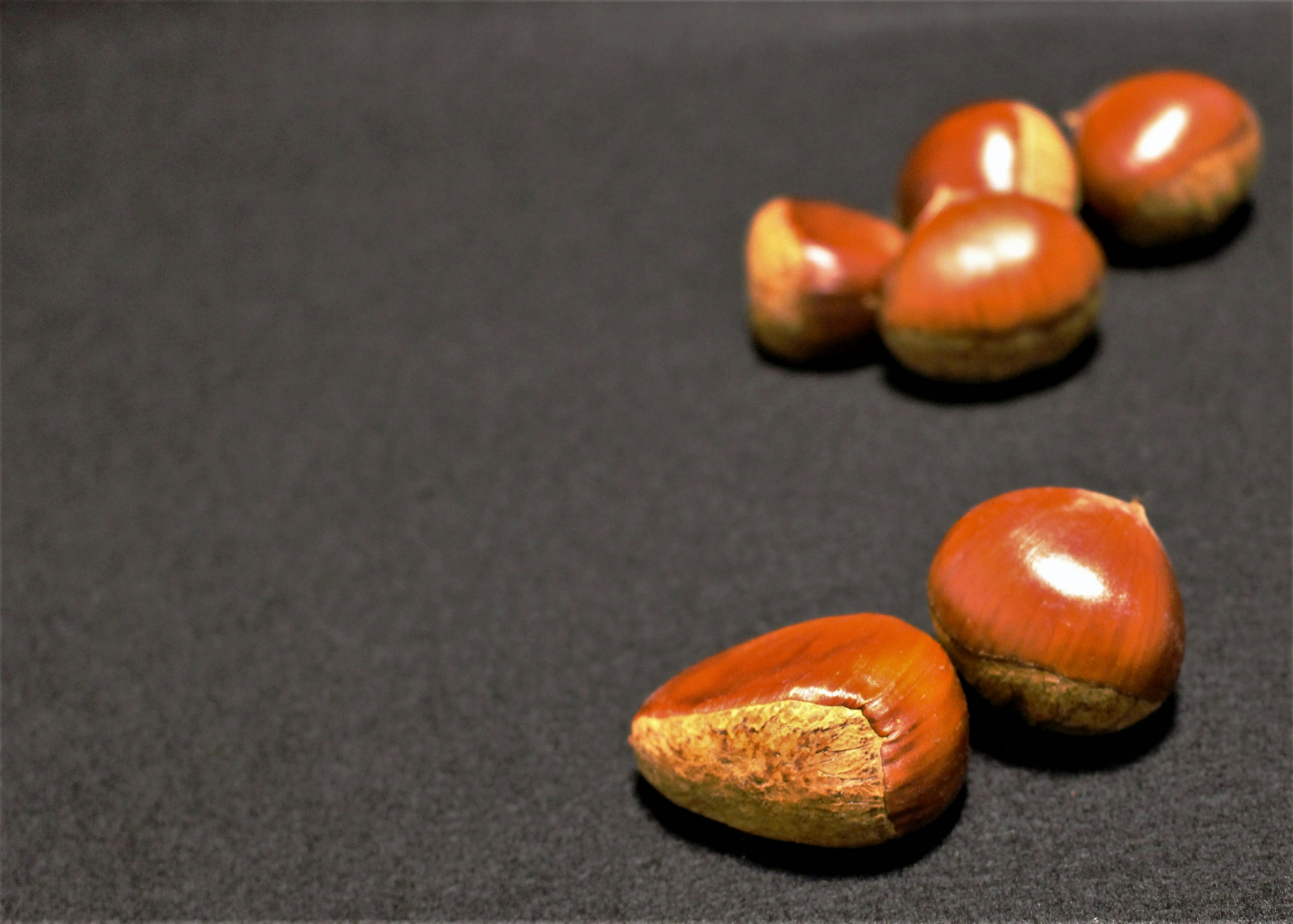 Chestnuts arranged on a black background