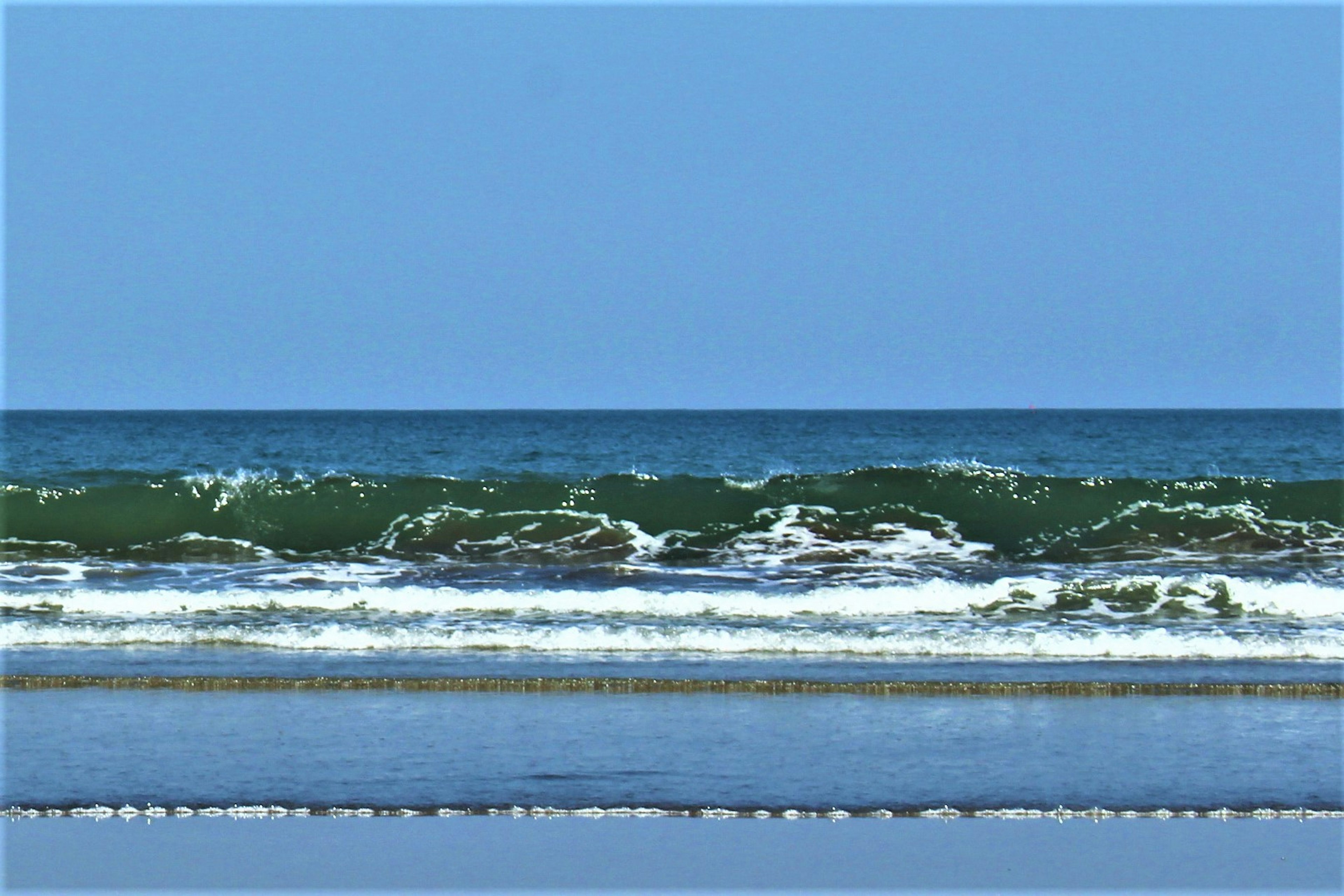 Scenic view of a blue sky and ocean waves