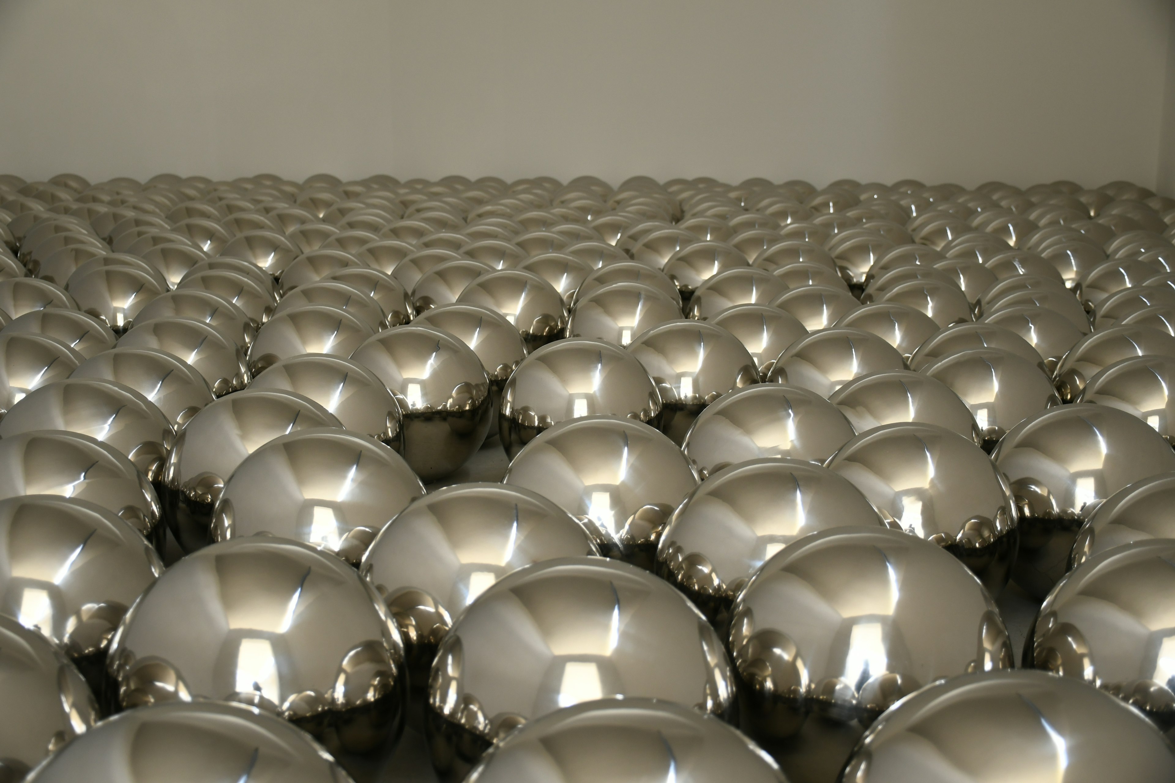 Metallic spheres arranged in a systematic pattern in an art installation