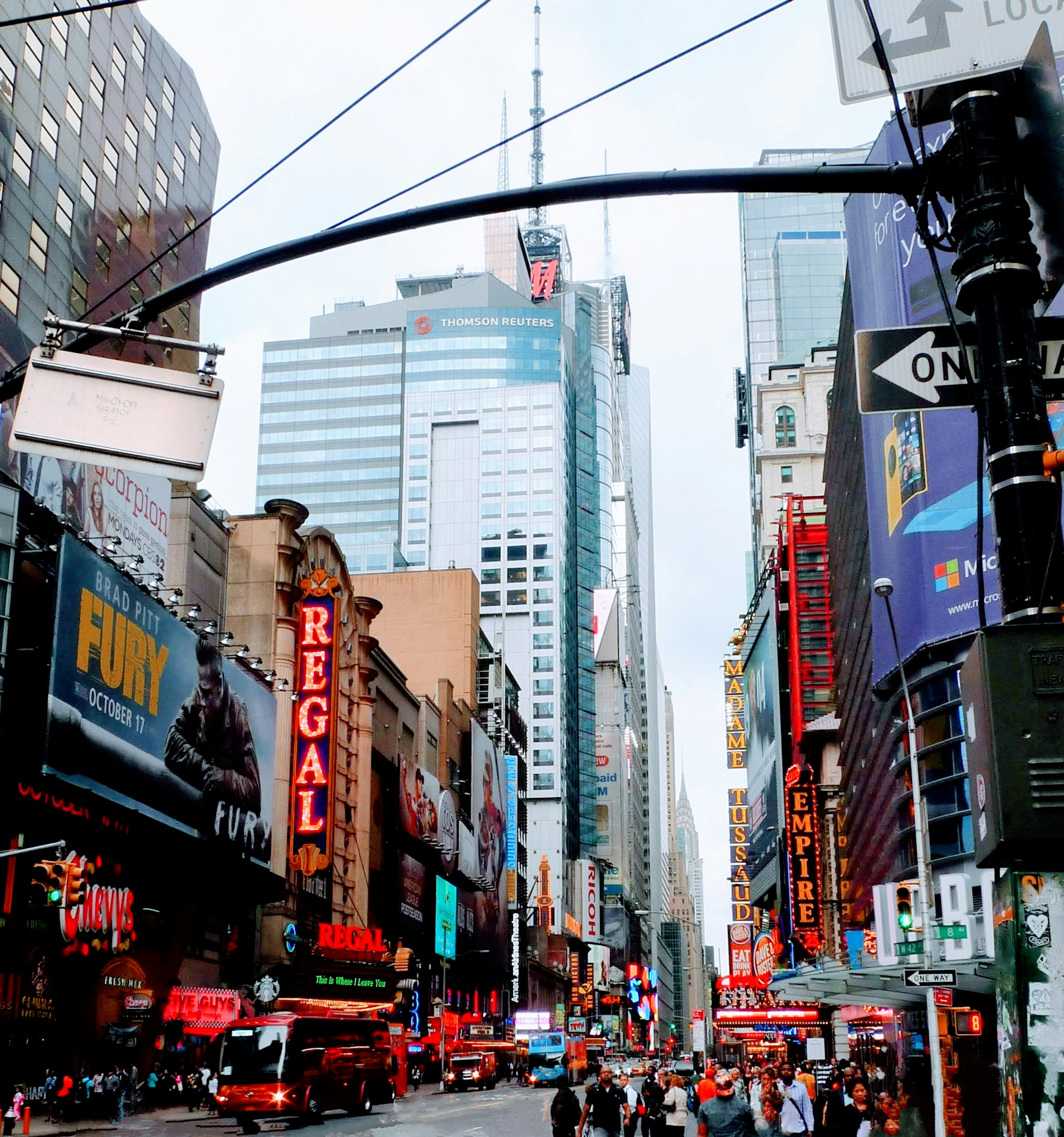 Busy street in Times Square with tall buildings and neon signs