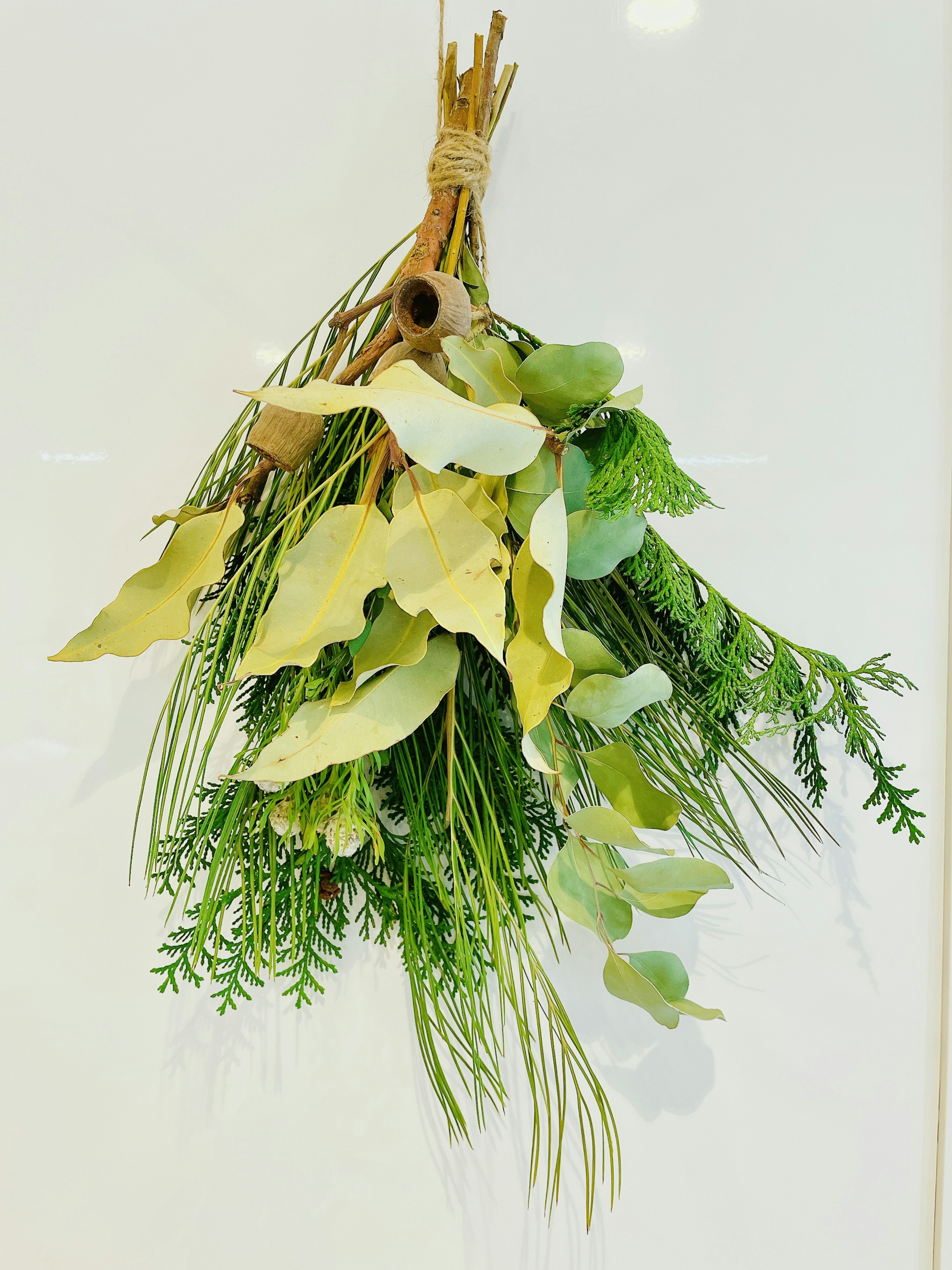 A bouquet of dried herbs and green leaves arranged gracefully