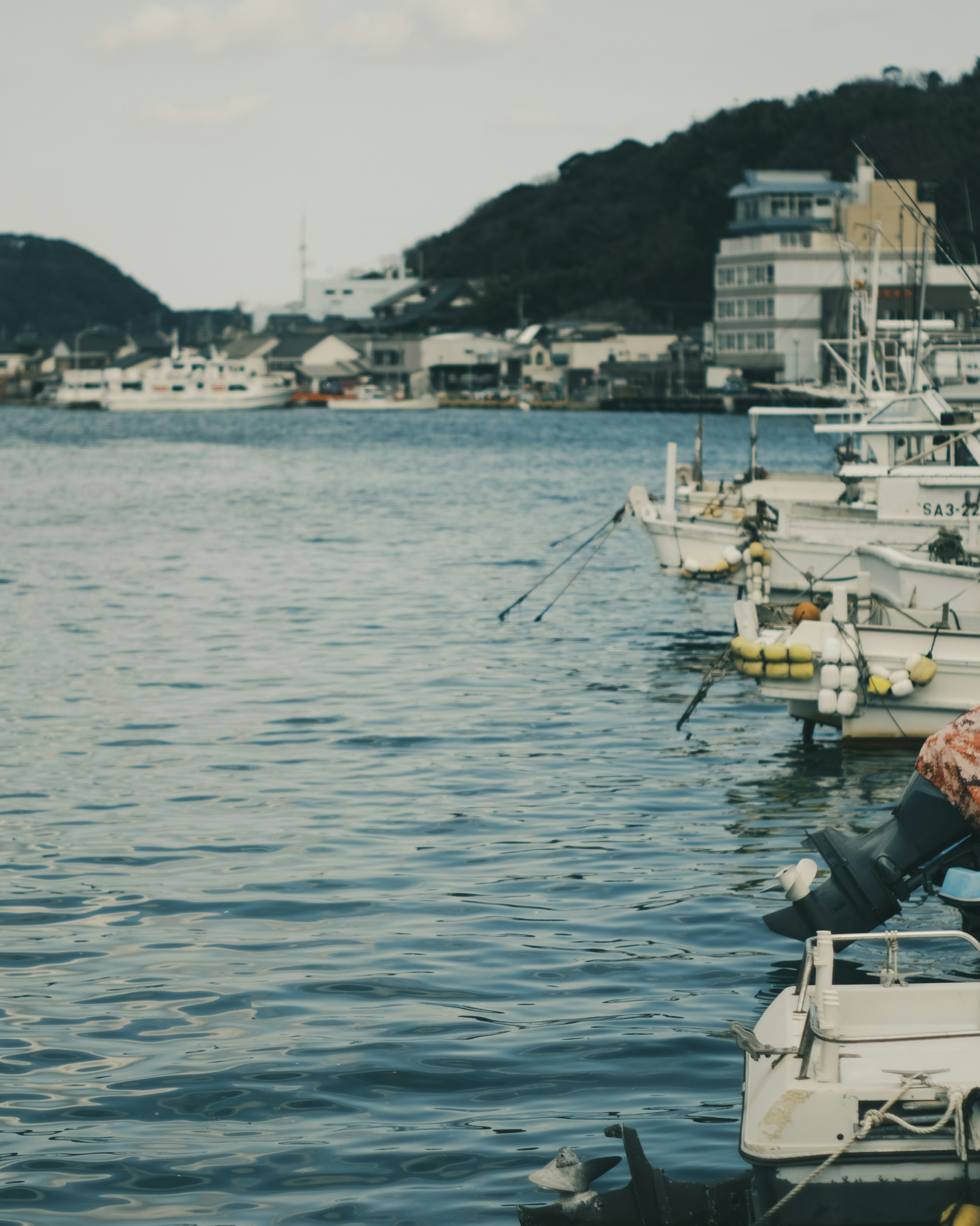 Calm water with fishing boats and harbor scenery