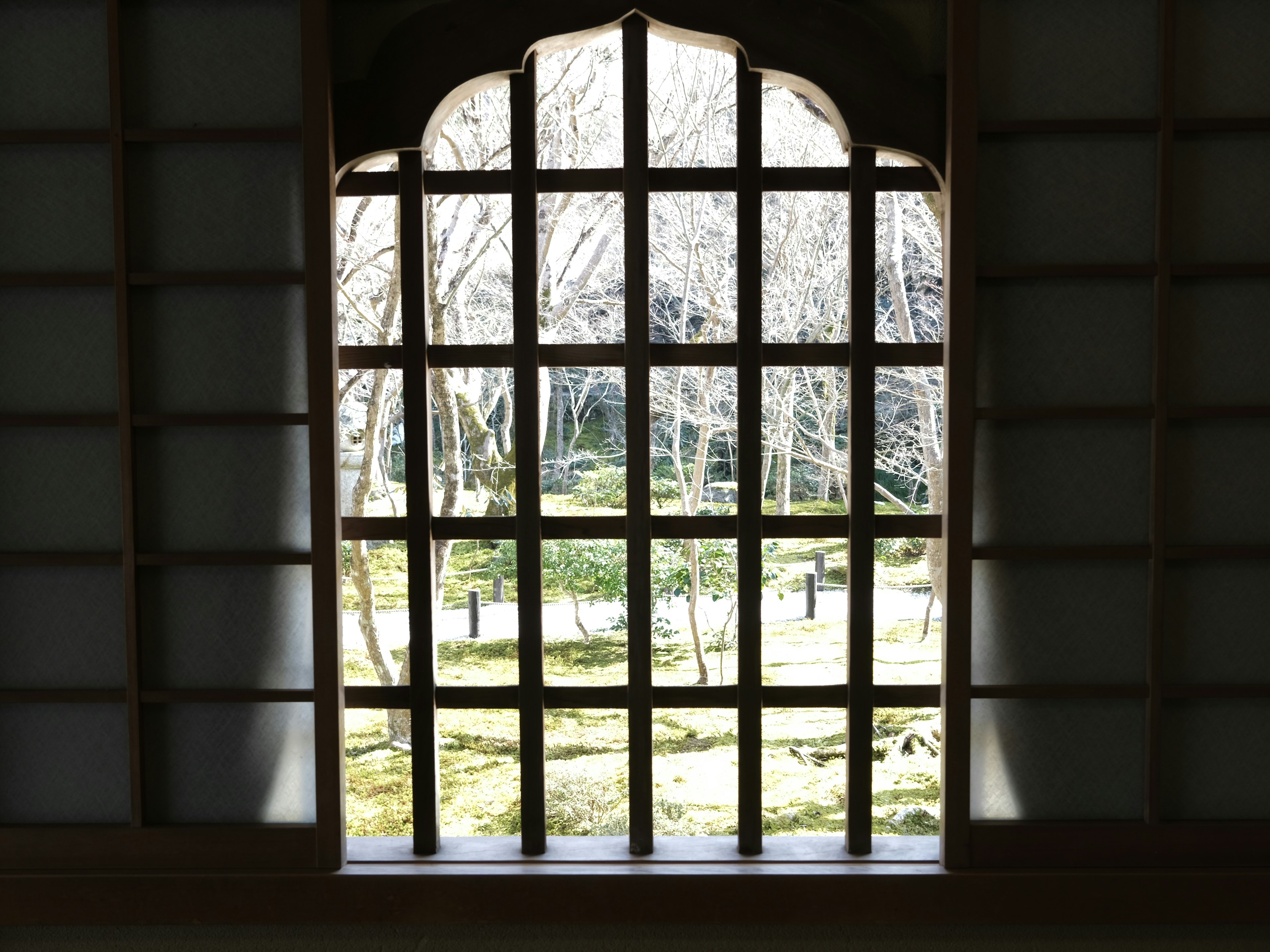 Interior view of a traditional Japanese window overlooking a beautiful garden