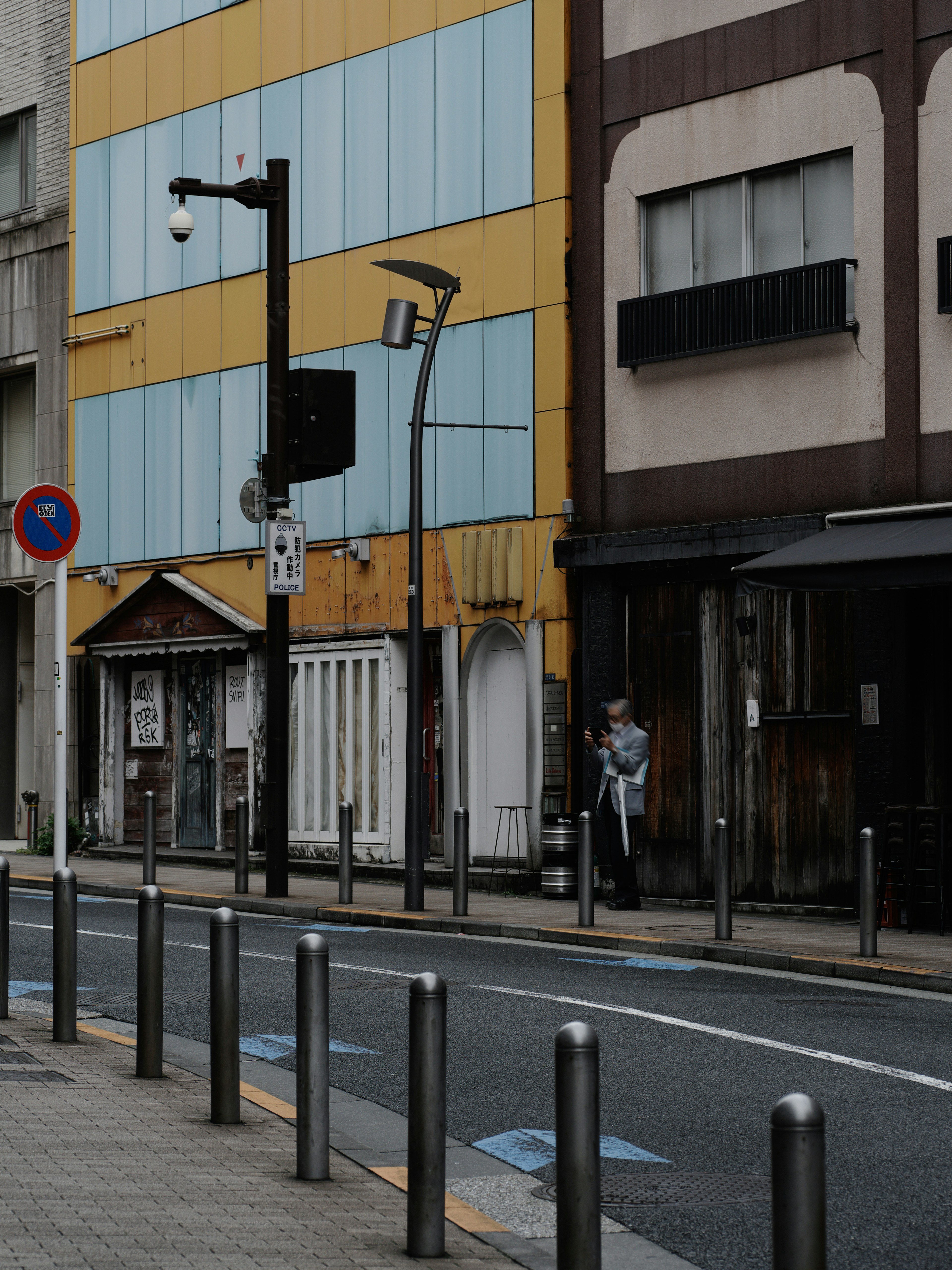 Street scene featuring buildings with yellow and blue striped walls